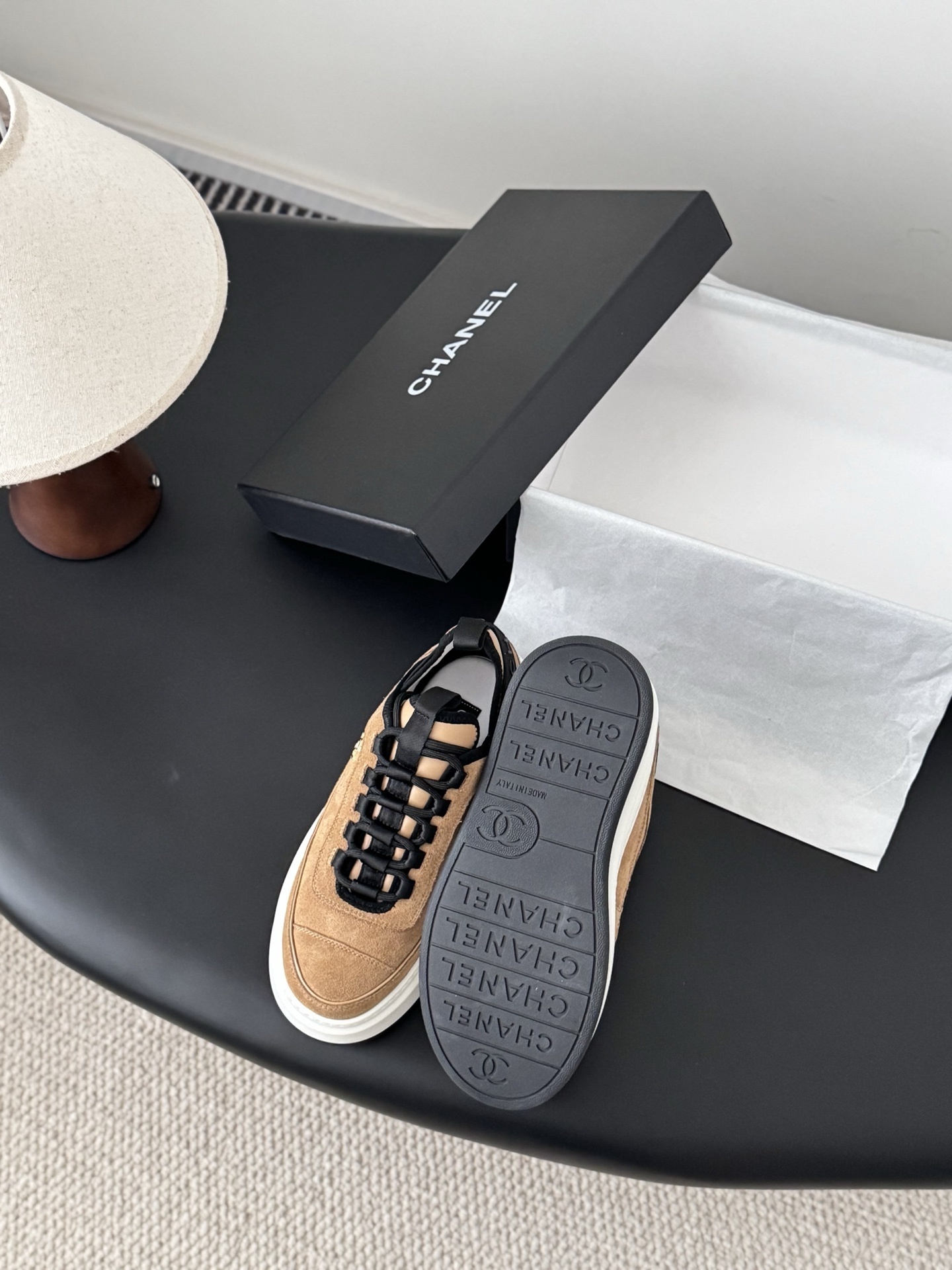 Pair of Chanel tan suede platform sneakers with black laces and thick white soles, featuring a gold CC logo on the side. - Hình 4