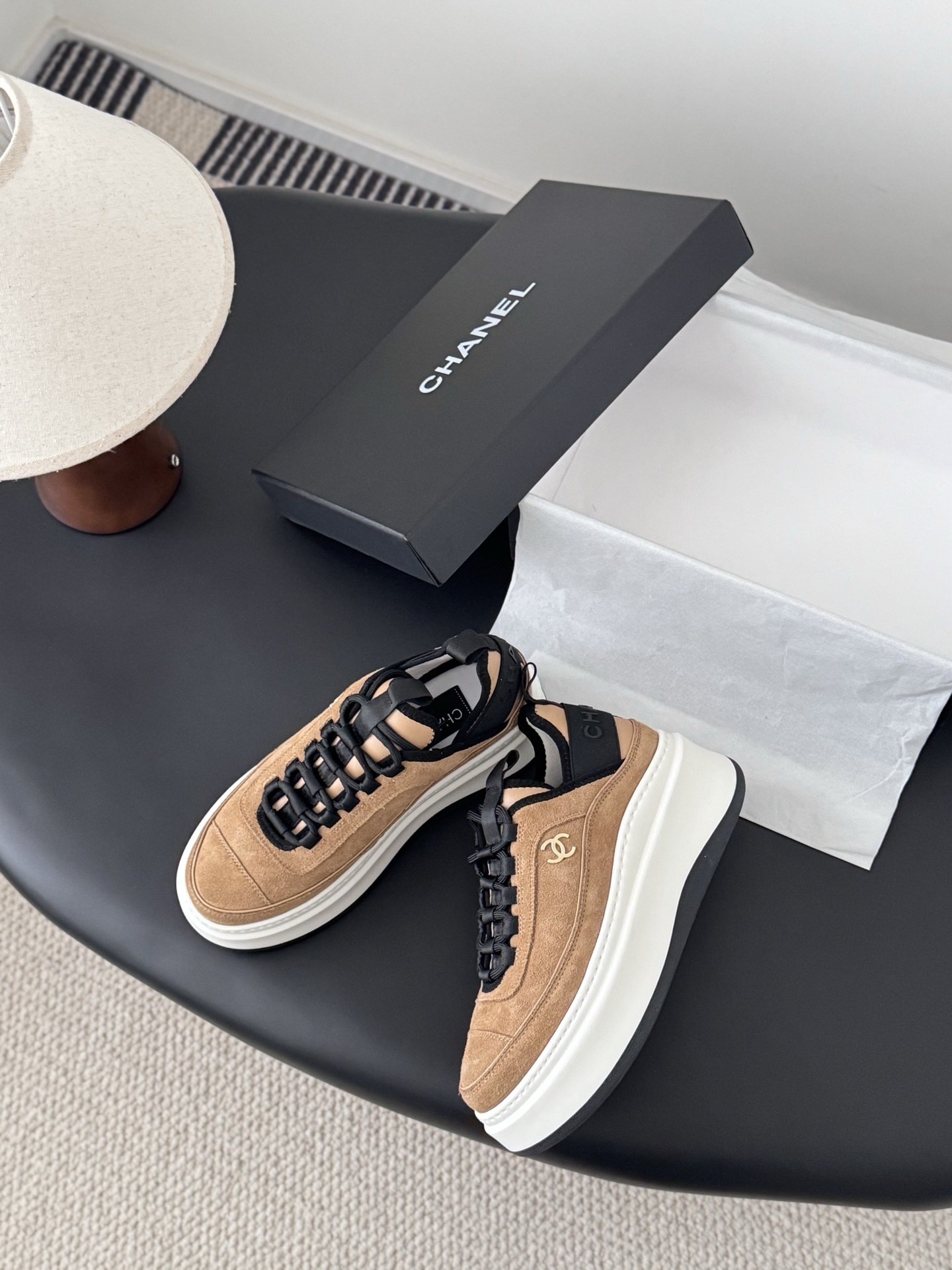 Pair of Chanel tan suede platform sneakers with black laces and thick white soles, featuring a gold CC logo on the side. - Hình 3