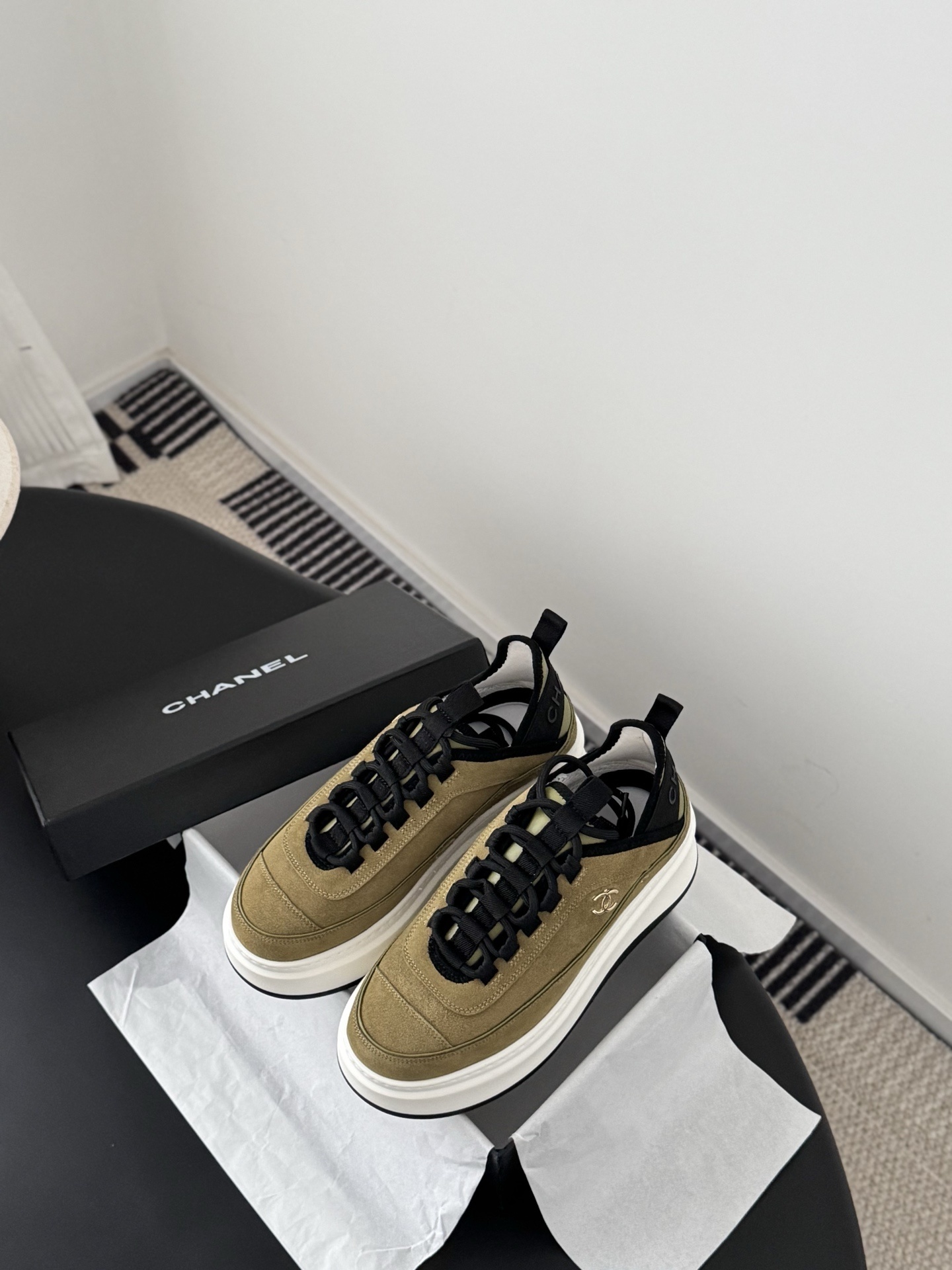 Chanel olive green suede platform sneakers with black accents and white chunky soles next to a black Chanel box. - Hình 6
