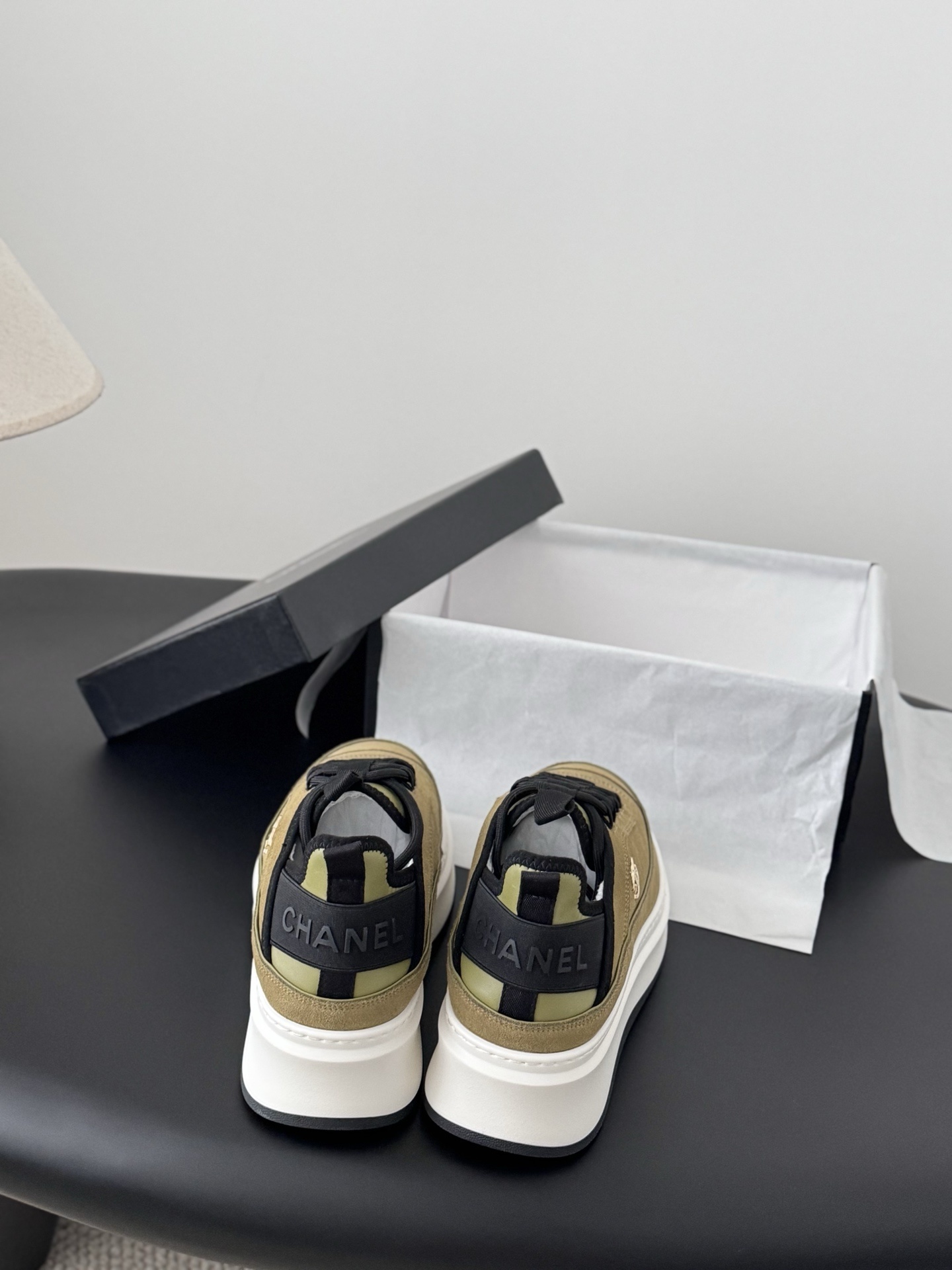 Chanel olive green suede platform sneakers with black accents and white chunky soles next to a black Chanel box. - Hình 5