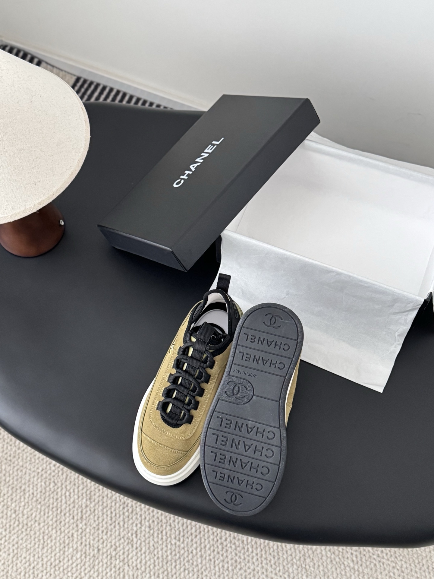 Chanel olive green suede platform sneakers with black accents and white chunky soles next to a black Chanel box. - Hình 4