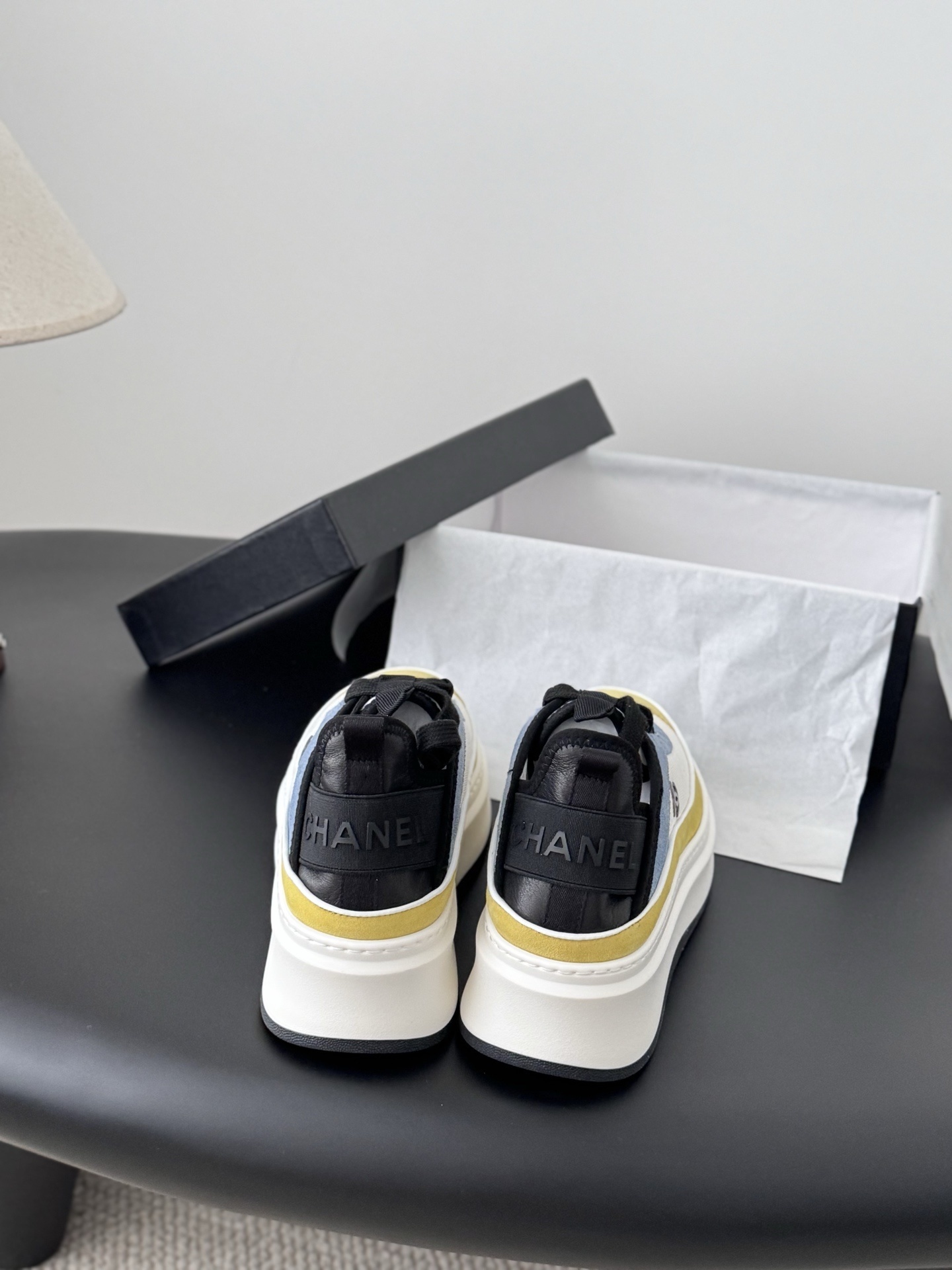 Pair of Chanel multi-color platform sneakers in yellow, blue, and white with black laces and CC logo next to original box - Hình 5