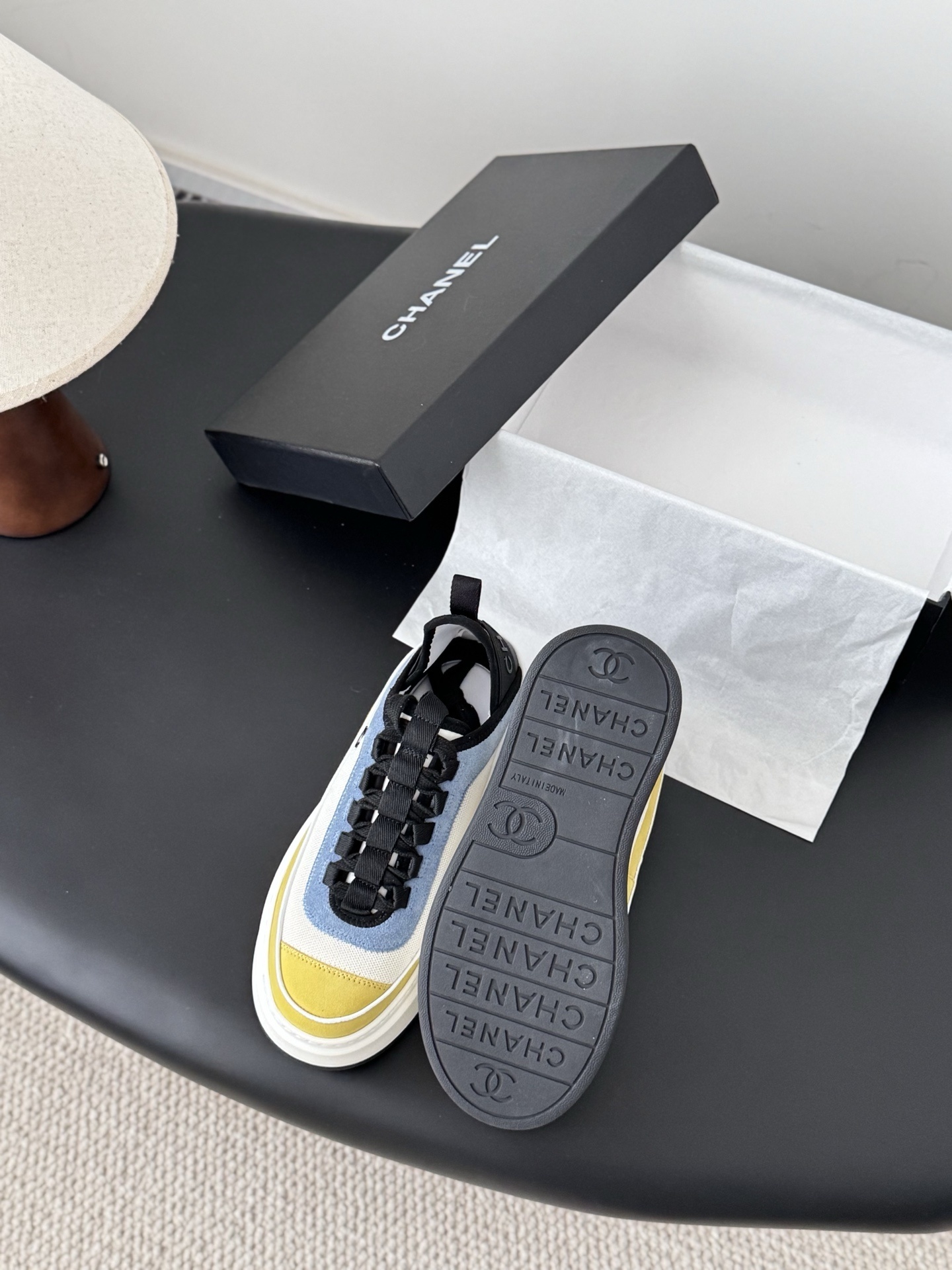 Pair of Chanel multi-color platform sneakers in yellow, blue, and white with black laces and CC logo next to original box - Hình 4