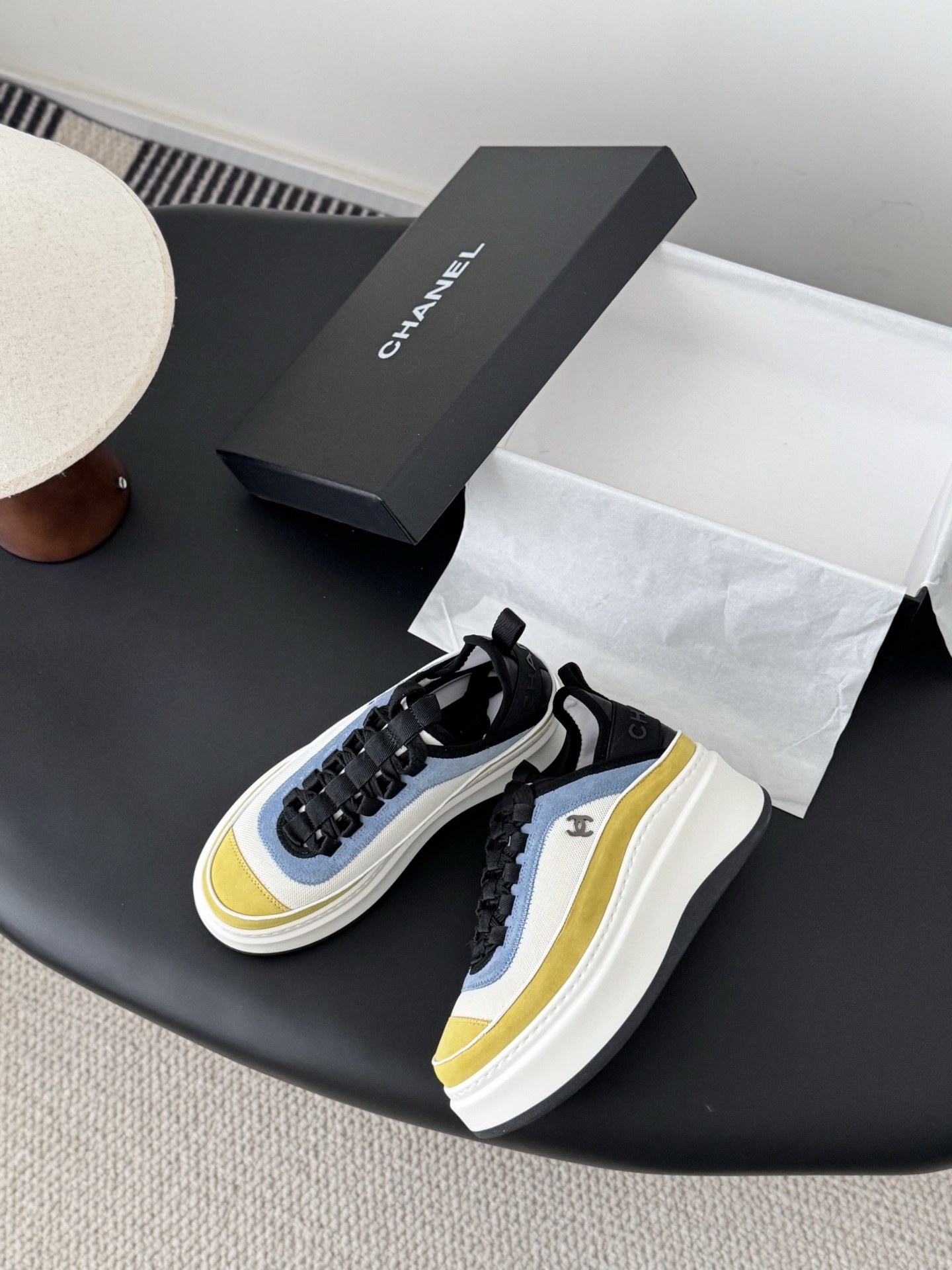 Pair of Chanel multi-color platform sneakers in yellow, blue, and white with black laces and CC logo next to original box - Hình 3