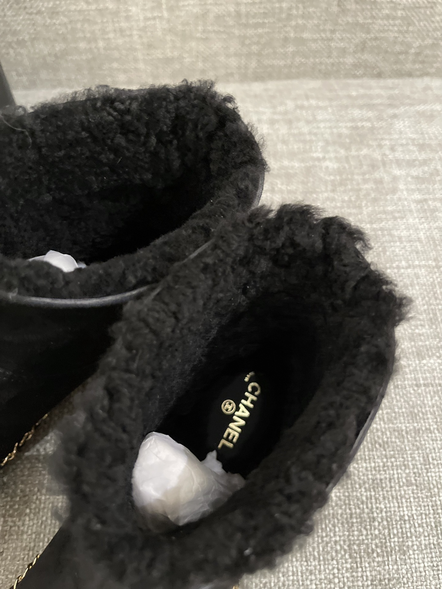 Pair of black Chanel suede ankle boots with shearling lining and gold chain trim around the sole - Hình 6