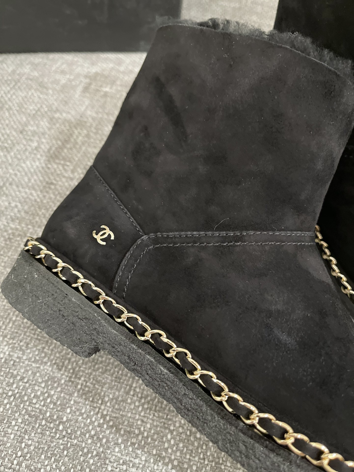 Pair of black Chanel suede ankle boots with shearling lining and gold chain trim around the sole - Hình 4