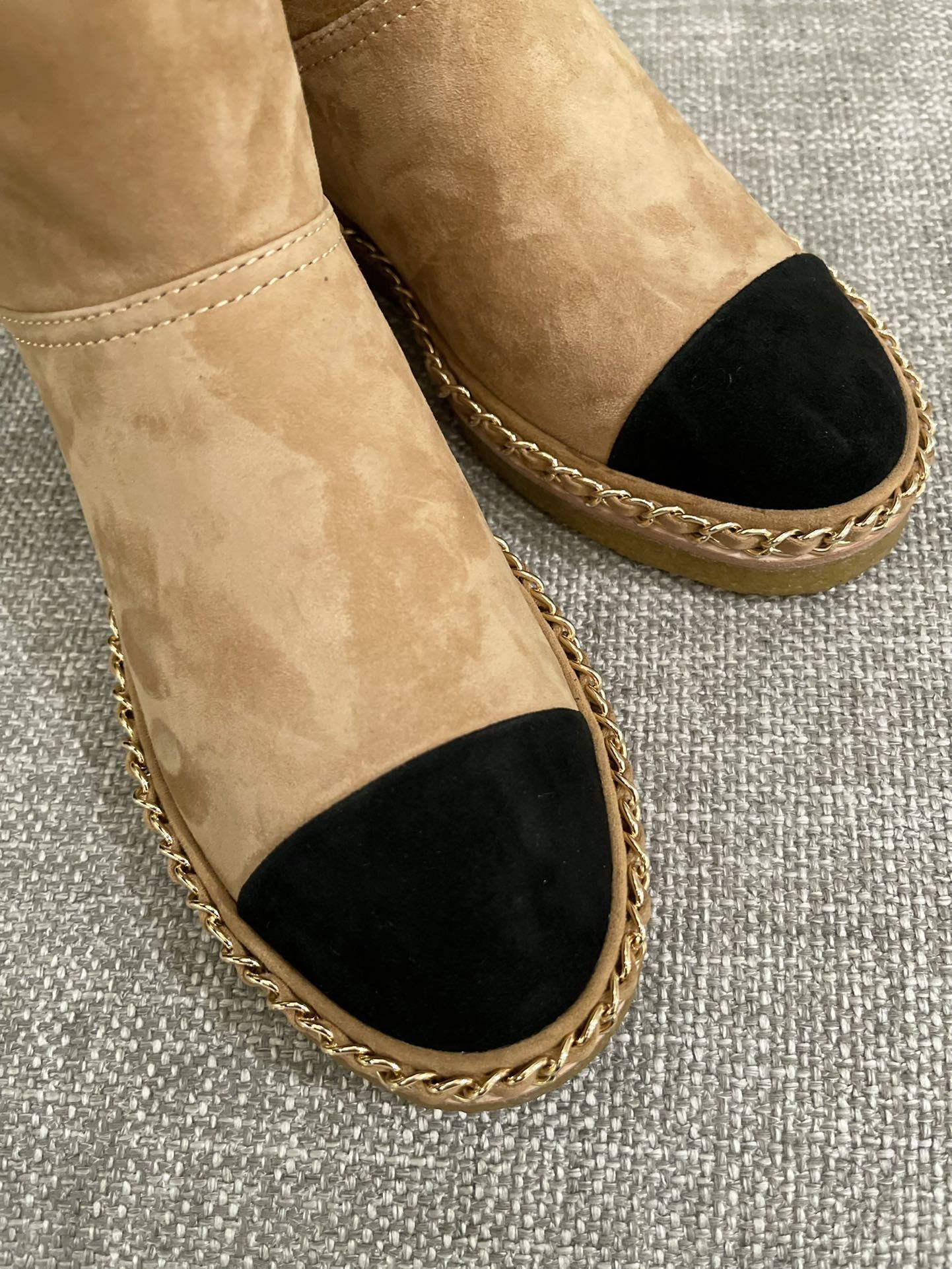 Pair of Chanel tan suede ankle boots with white shearling lining, black cap-toe, and gold chain sole detail. - Hình 5