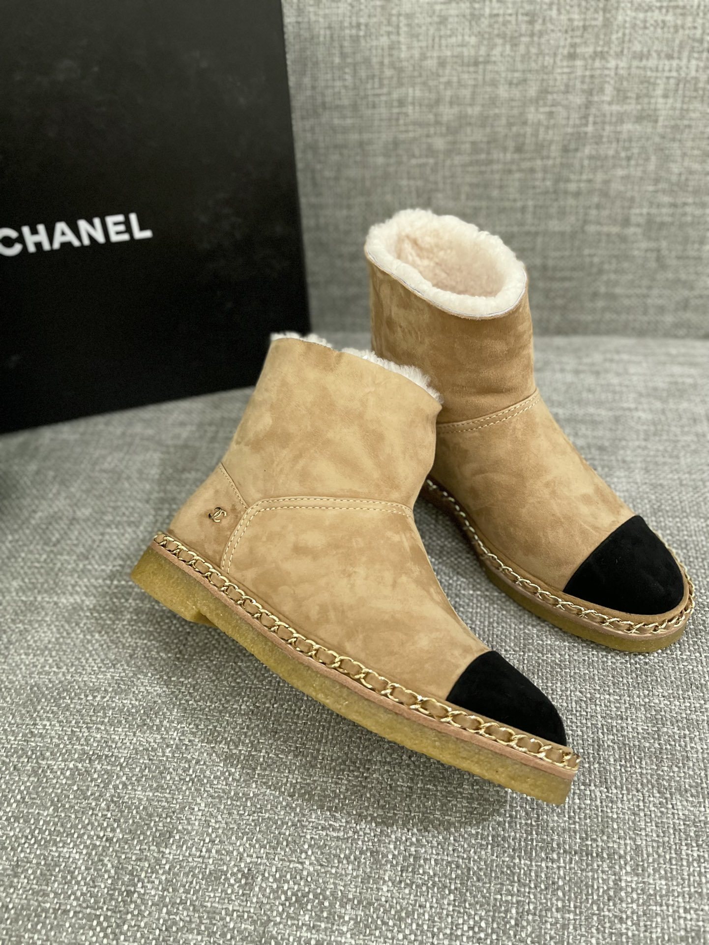 Pair of Chanel tan suede ankle boots with white shearling lining, black cap-toe, and gold chain sole detail. - Hình 4