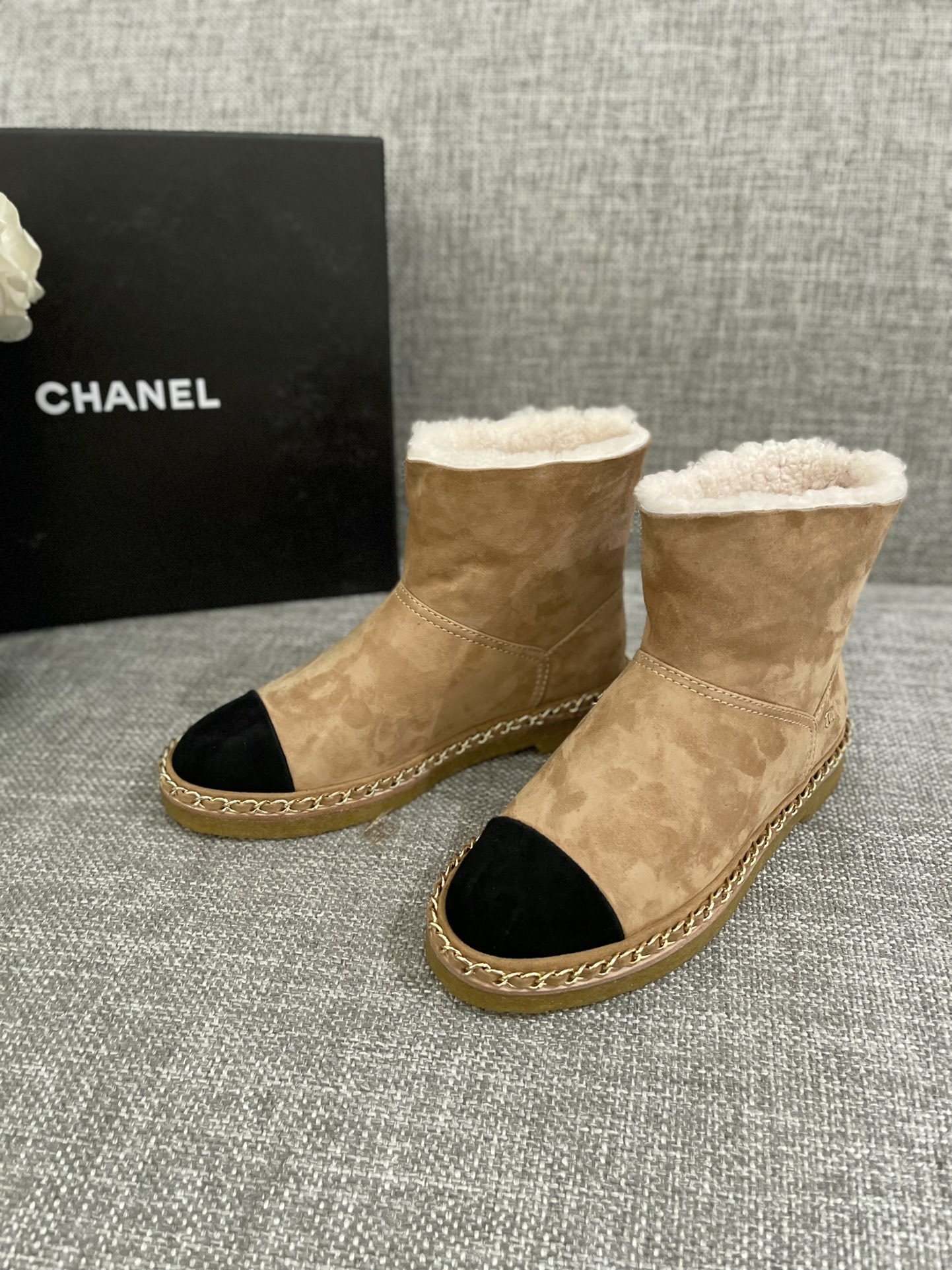 Pair of Chanel tan suede ankle boots with white shearling lining, black cap-toe, and gold chain sole detail. - Hình 3