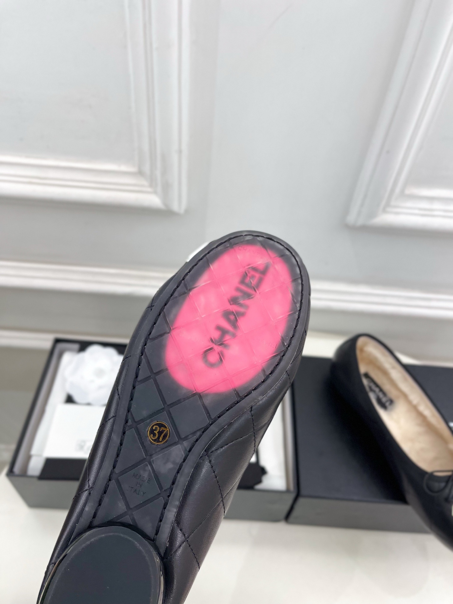 Black Chanel quilted leather ballerina flats with white CC logo and fur lining shown with luxury packaging - Hình 9
