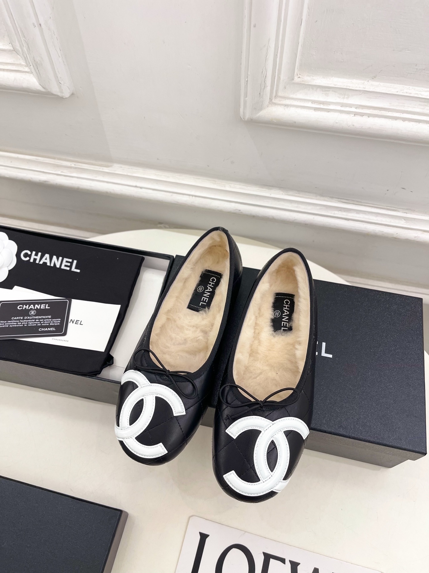 Black Chanel quilted leather ballerina flats with white CC logo and fur lining shown with luxury packaging - Hình 5