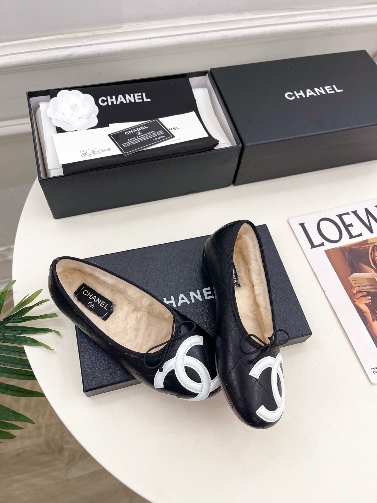 Black Chanel quilted leather ballerina flats with white CC logo and fur lining shown with luxury packaging - Hình 4