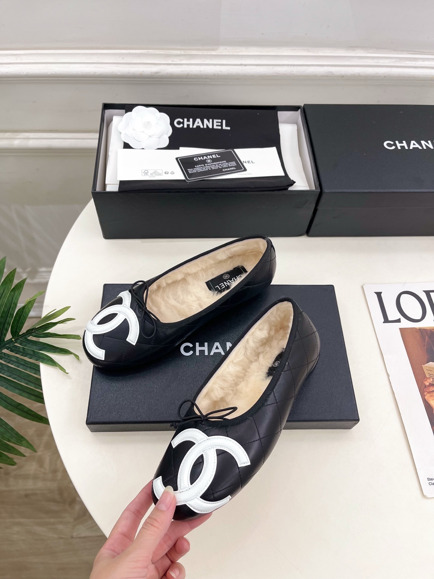 Black Chanel quilted leather ballerina flats with white CC logo and fur lining shown with luxury packaging - Hình 3