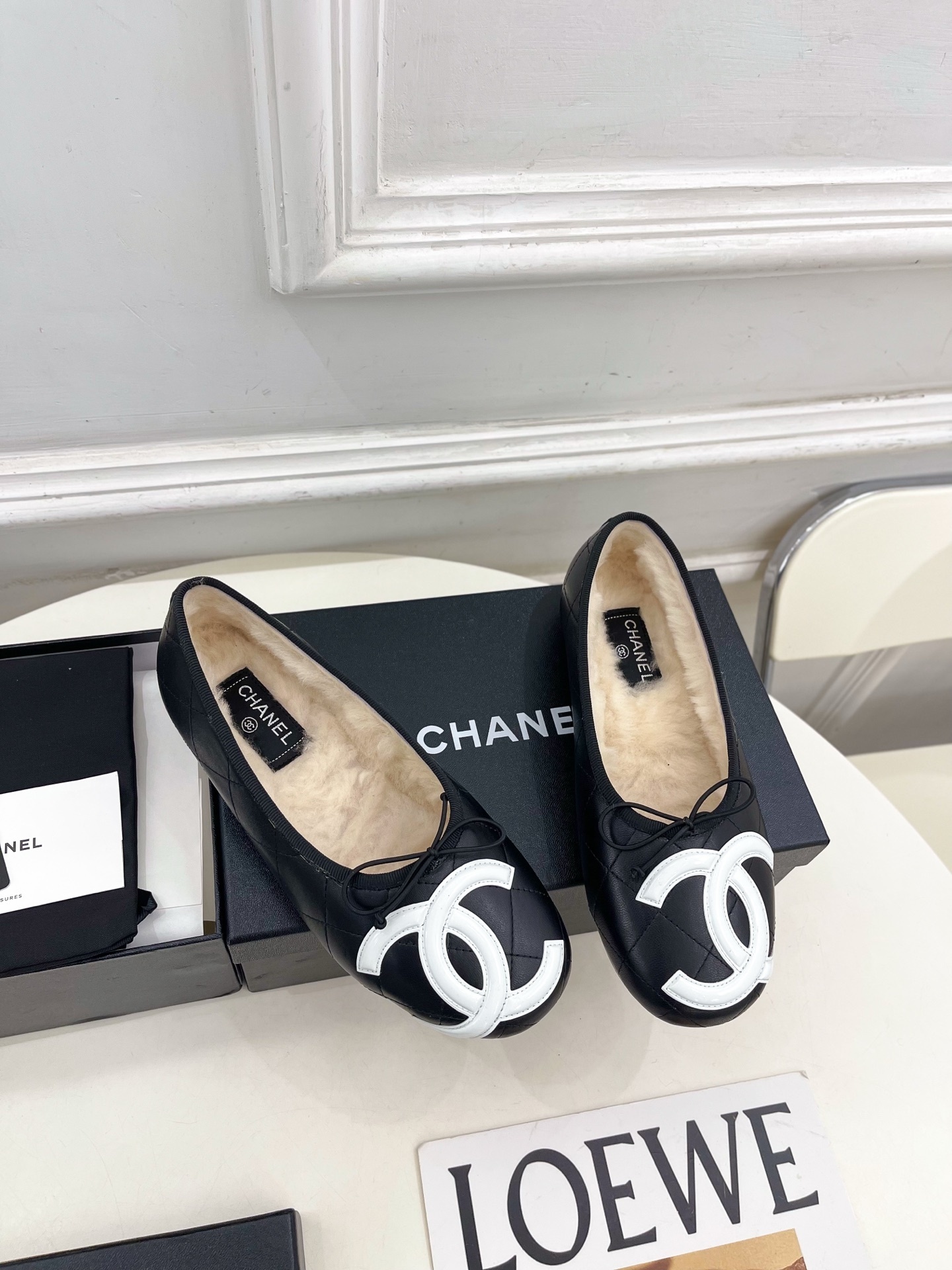 Black Chanel quilted leather ballerina flats with white CC logo and fur lining shown with luxury packaging - Hình 2