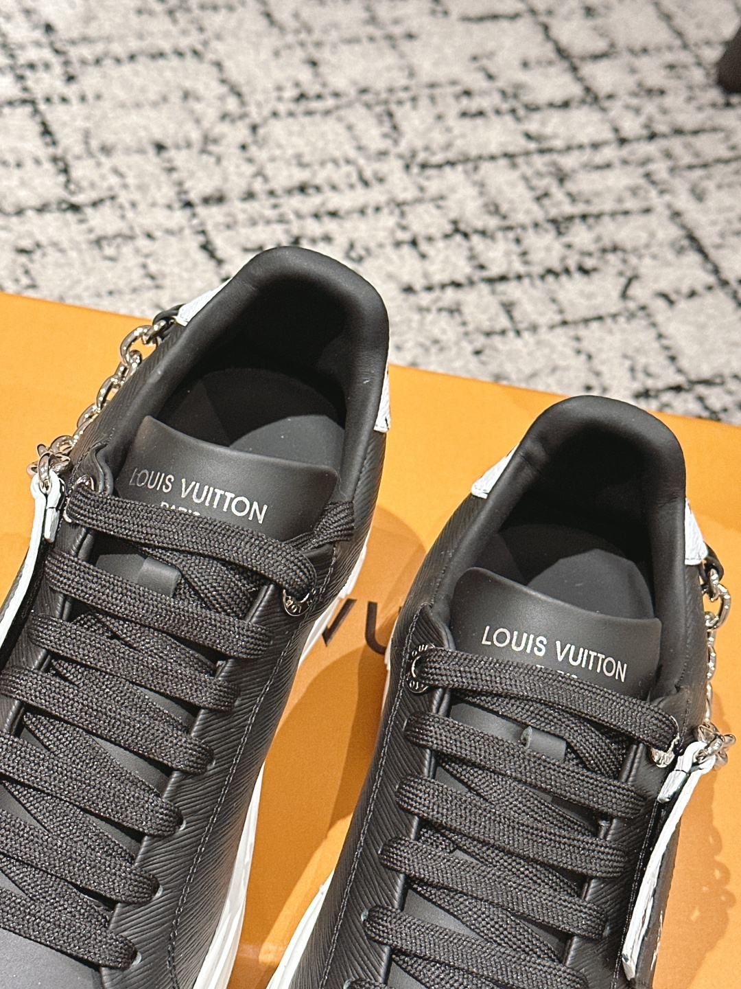 Louis Vuitton Women's Black Leather Sneakers with Gold Chain Detail