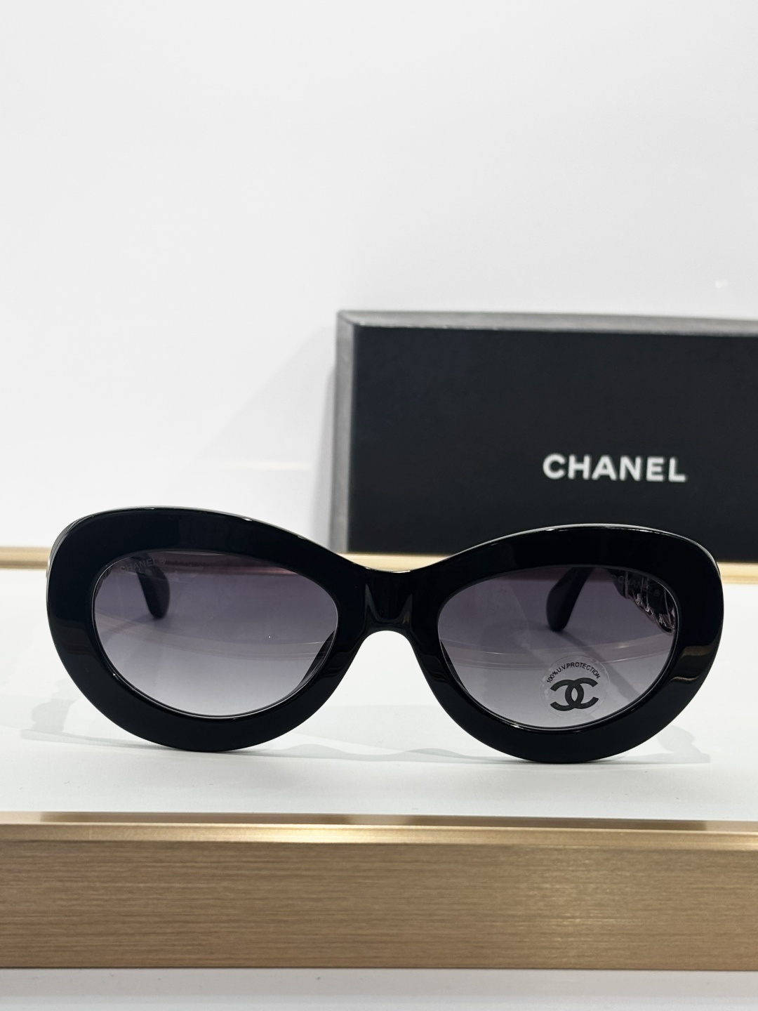 Chanel Luxury Oval Sunglasses - Black Frame with Gold Chain Detail