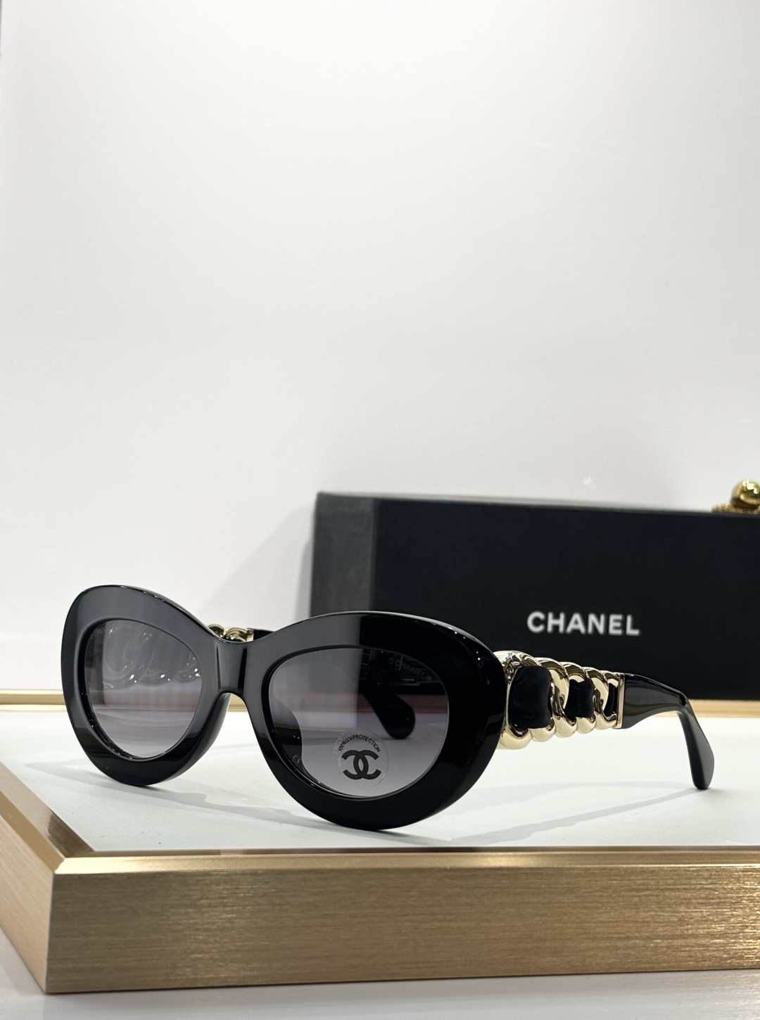 Chanel Luxury Oval Sunglasses - Black Frame with Gold Chain Detail