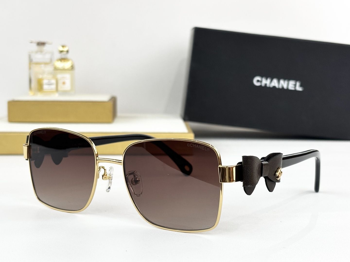 Luxury Chanel Gold Metal Sunglasses with Leather Bow & CC Logo