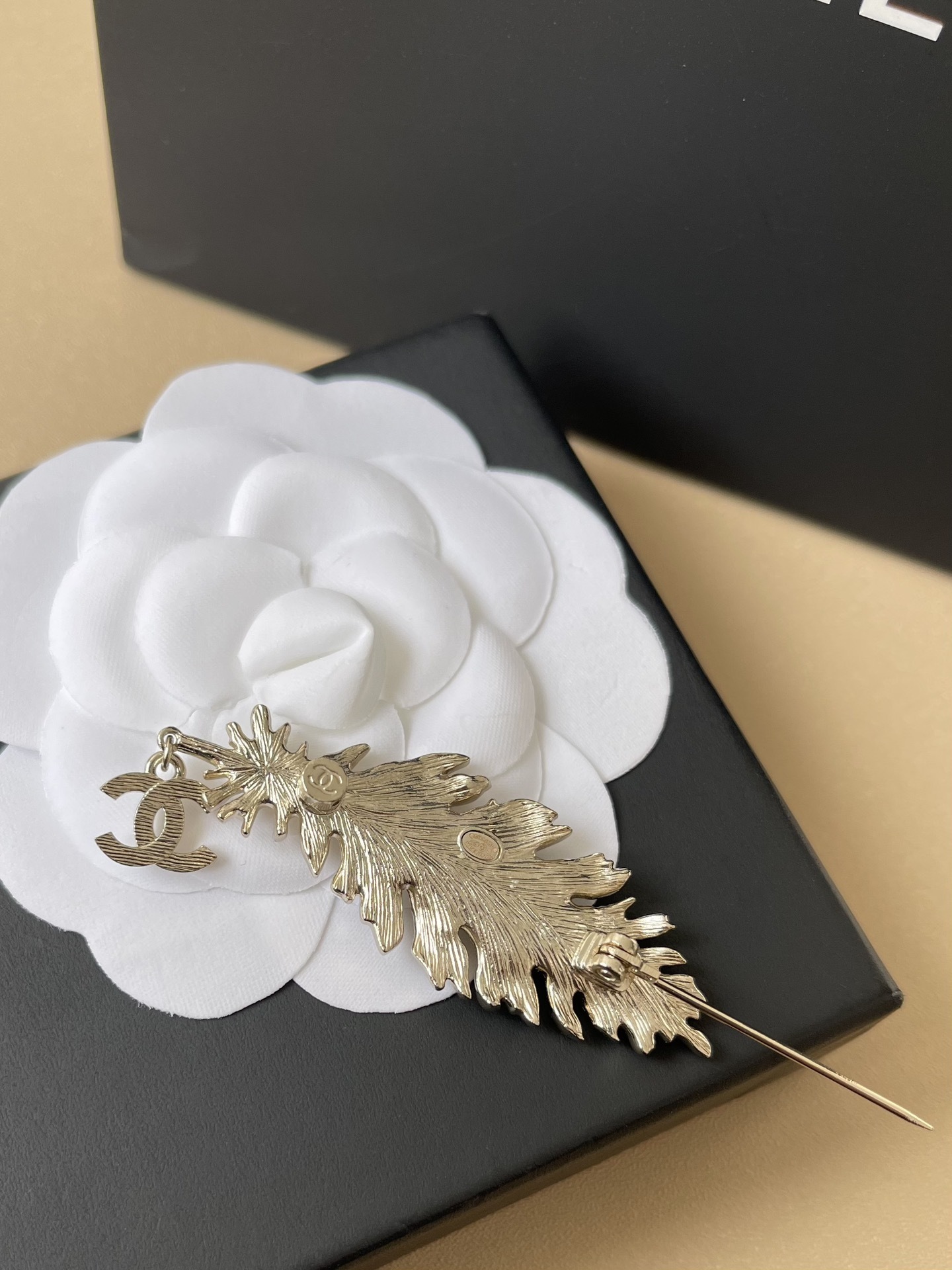 Elegant Crystal Feather Brooch with Iconic CC Logo Pendant
