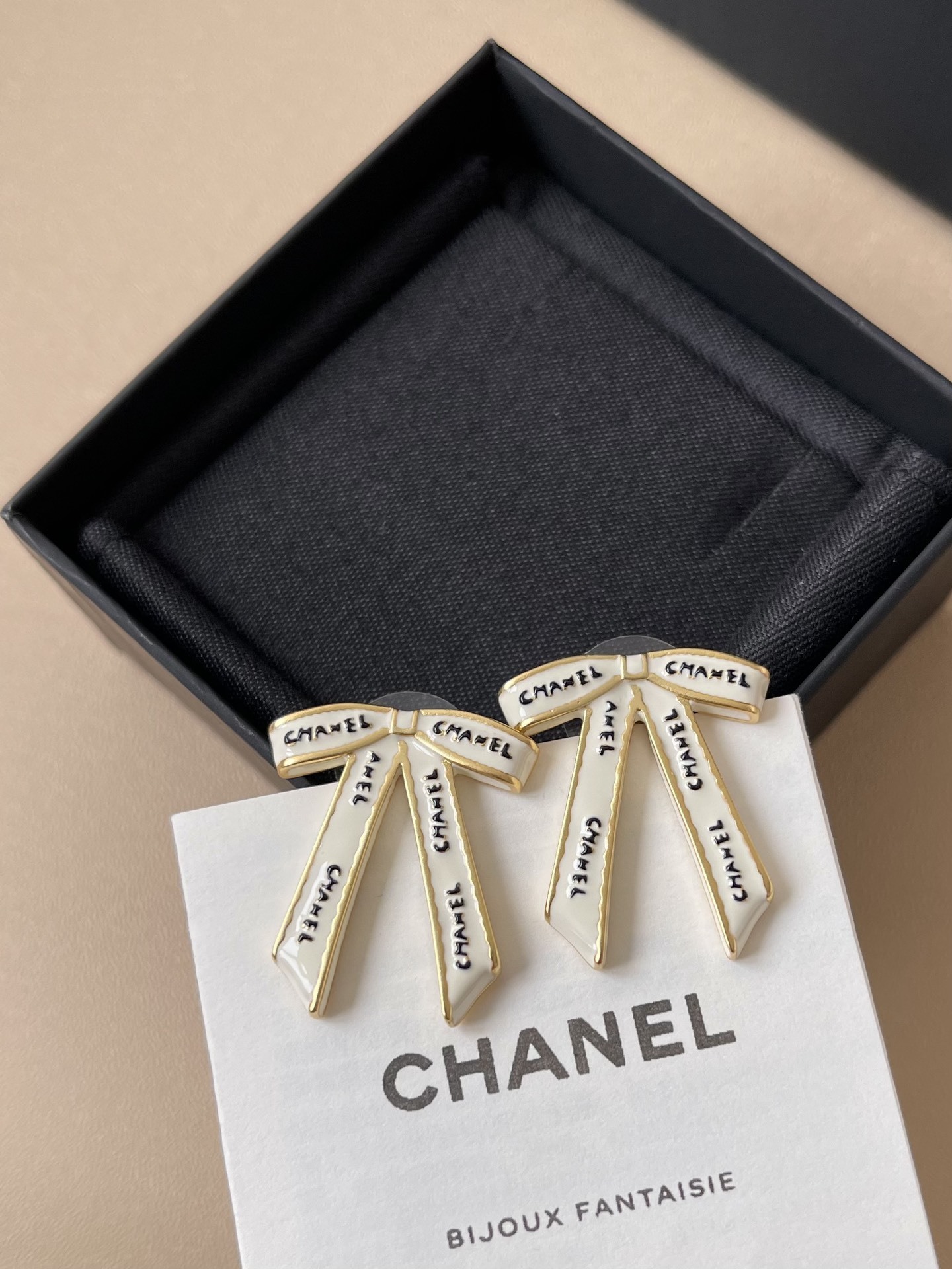 Chanel White Ribbon Bow Stud Earrings - Elegant Gold-Tone Jewelry
