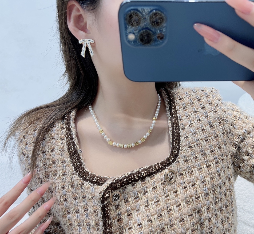 Chanel White Ribbon Bow Stud Earrings - Elegant Gold-Tone Jewelry