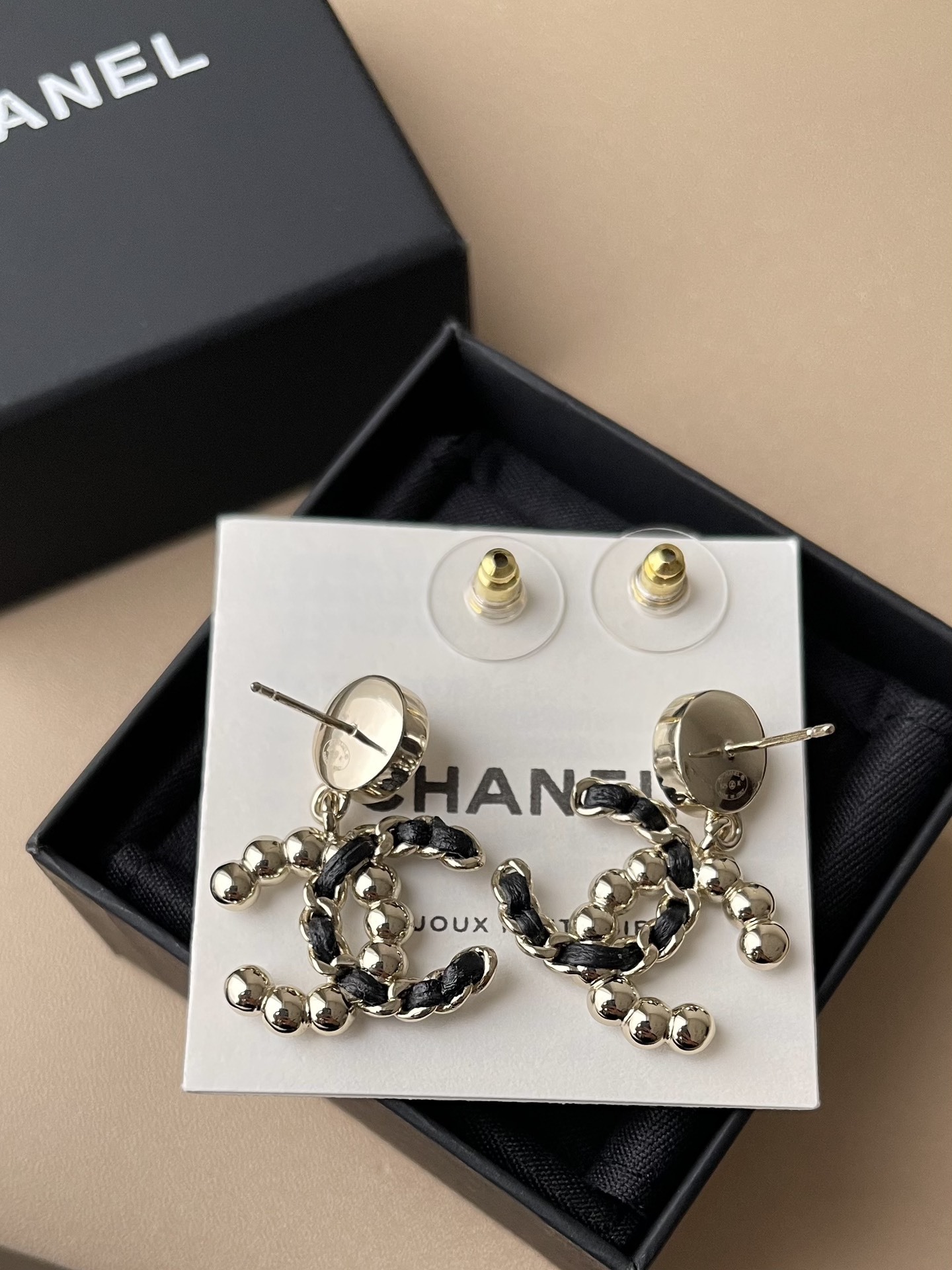 Elegant CC Logo Pearl Drop Earrings with Interwoven Black Leather