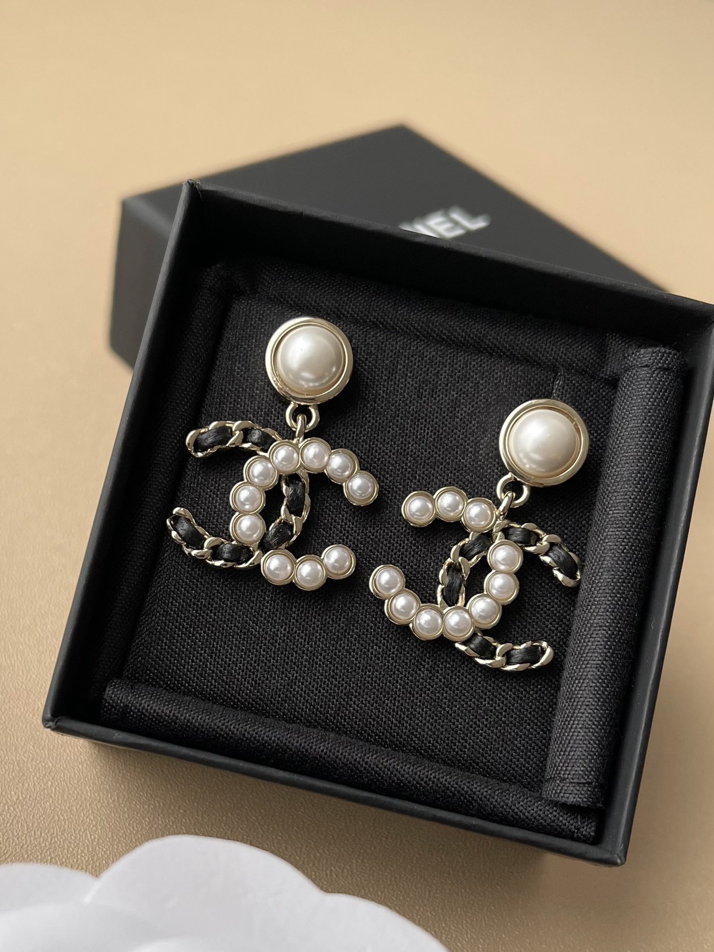 Elegant CC Logo Pearl Drop Earrings with Interwoven Black Leather