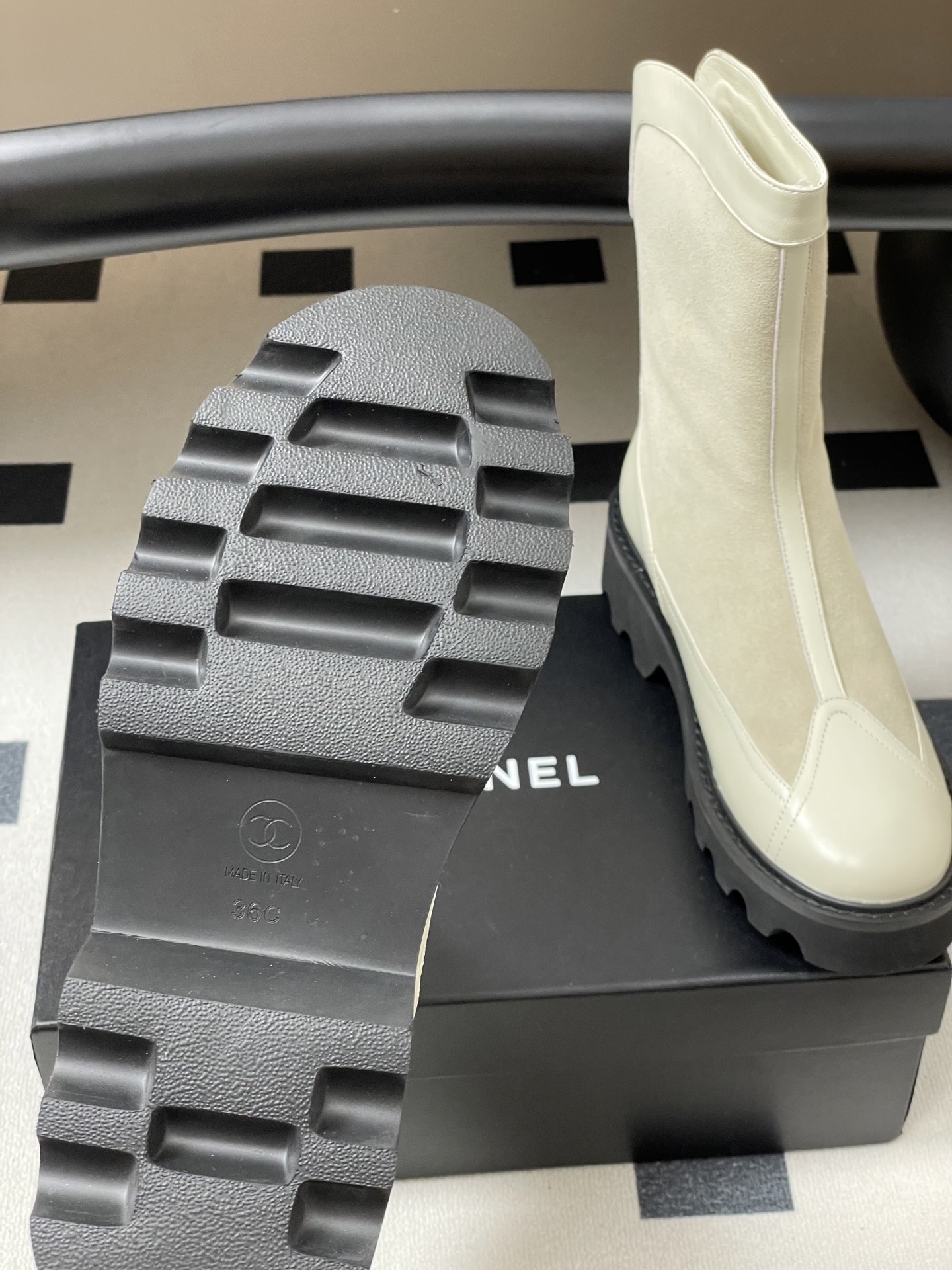 A pair of luxury Chanel off-white leather and suede mid-calf boots with thick black lug soles and gold CC logo detail. - Hình 7