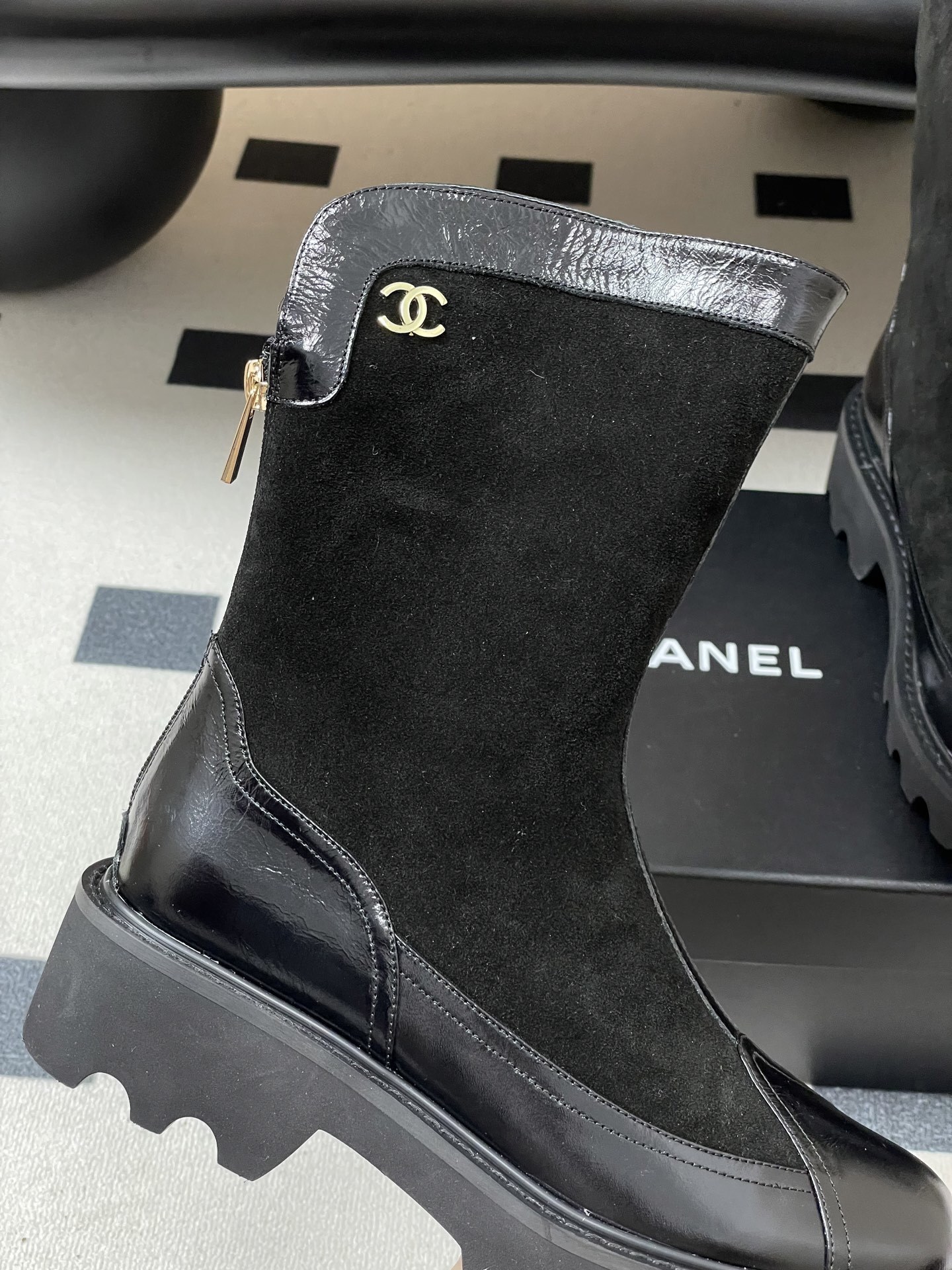 Pair of Chanel black suede and patent leather mid-calf boots with chunky lug soles and gold CC logo detail. - Hình 8