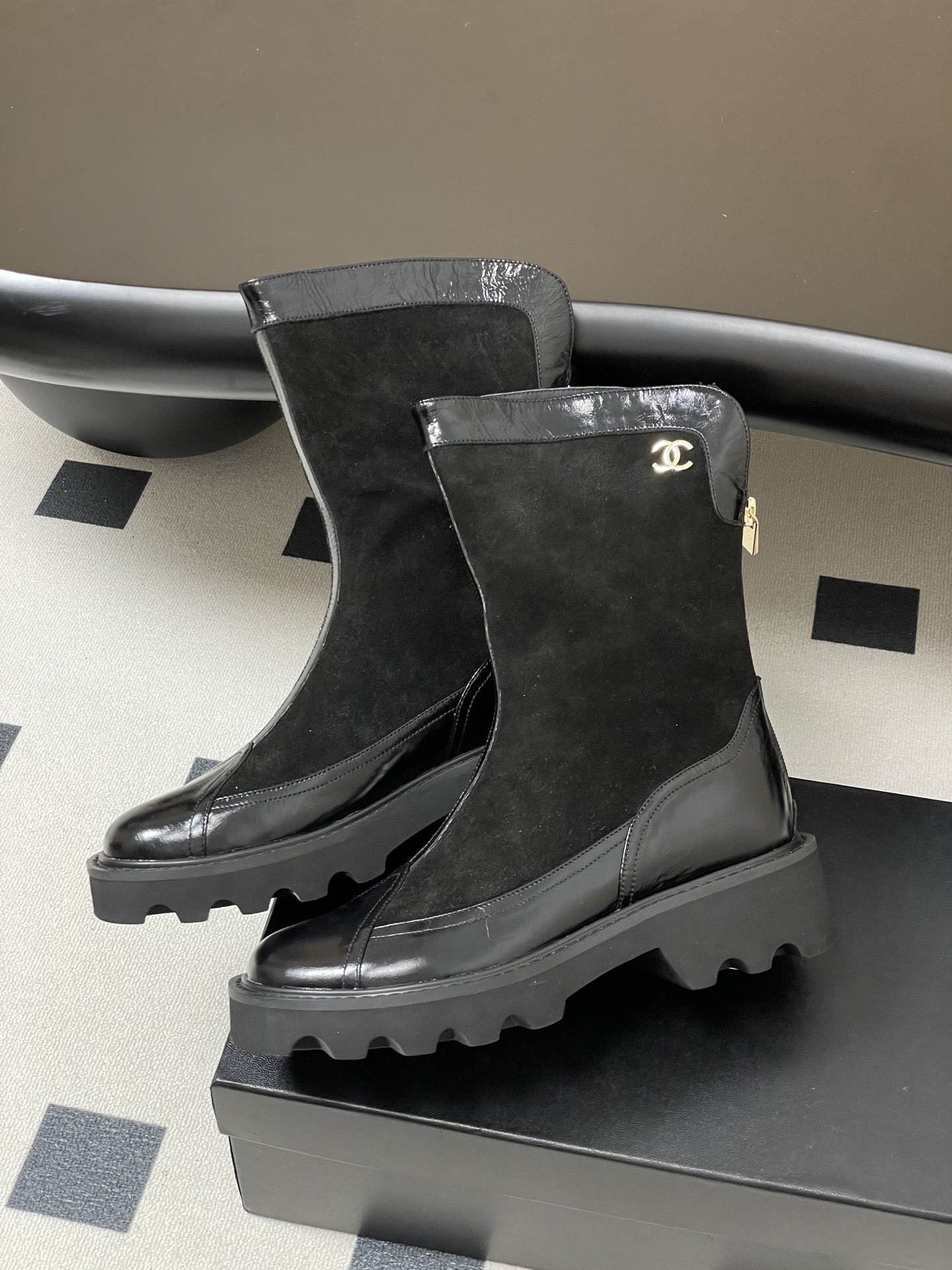 Pair of Chanel black suede and patent leather mid-calf boots with chunky lug soles and gold CC logo detail. - Hình 4