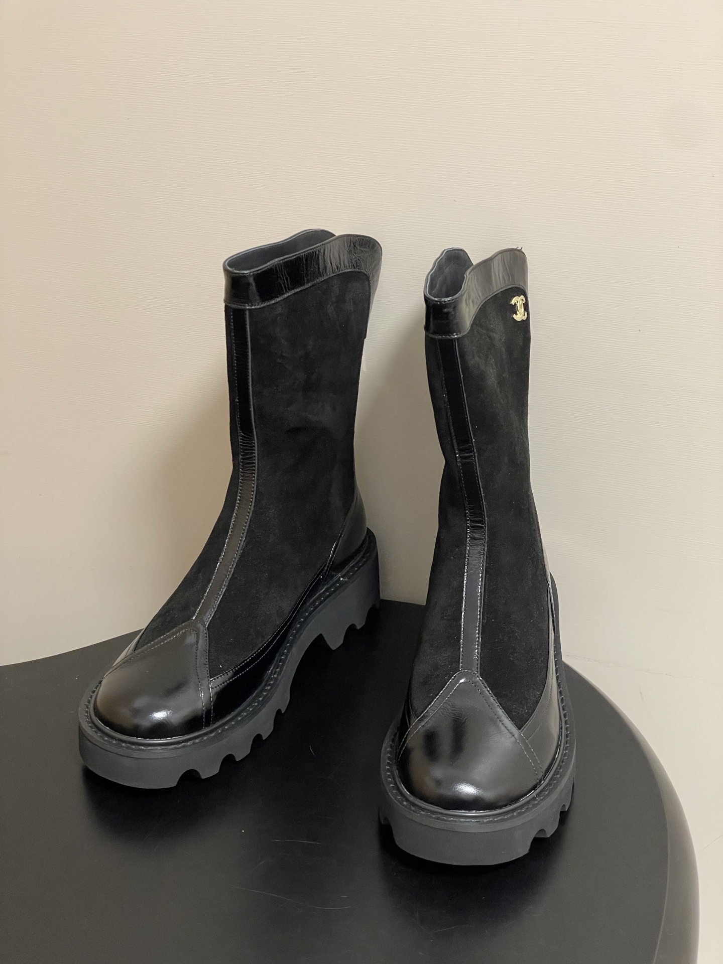 Pair of Chanel black suede and patent leather mid-calf boots with chunky lug soles and gold CC logo detail. - Hình 2