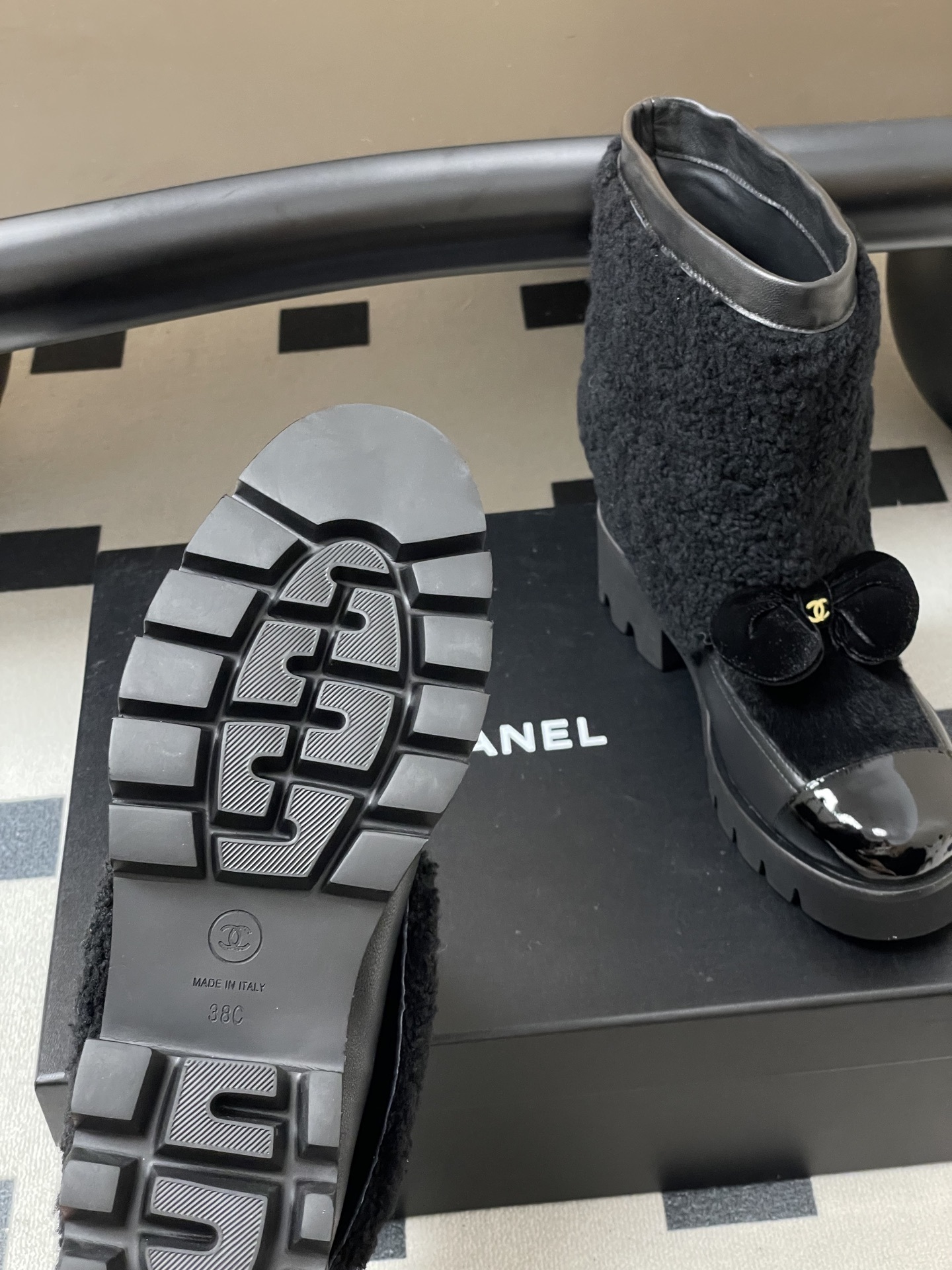 Pair of black luxury ankle boots with faux fur shearling shaft, velvet bow, and chunky lug soles - Hình 9