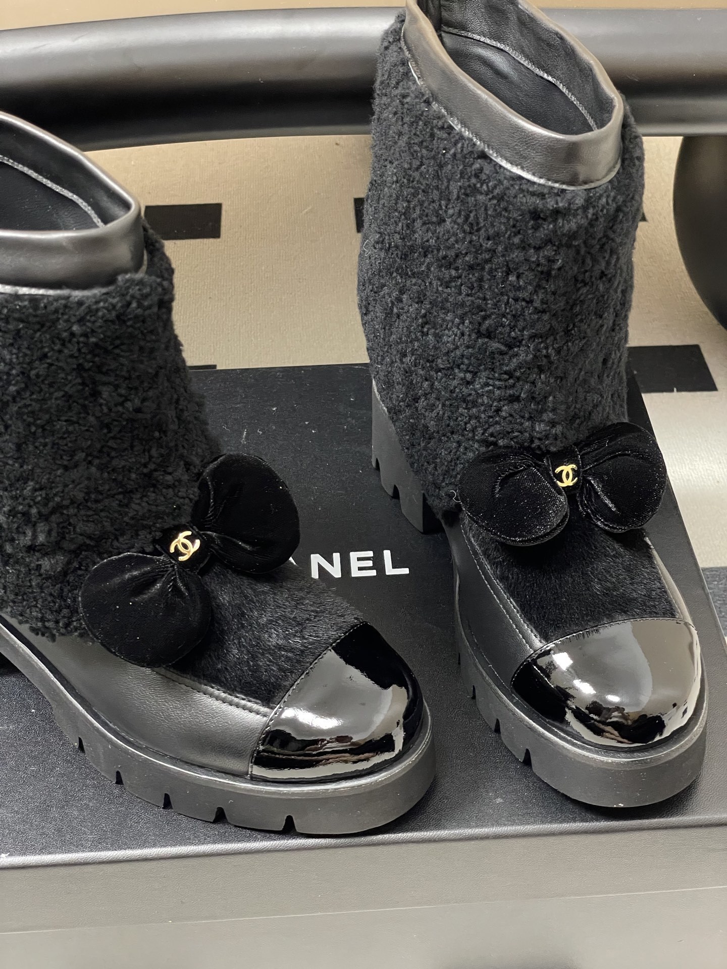 Pair of black luxury ankle boots with faux fur shearling shaft, velvet bow, and chunky lug soles - Hình 8