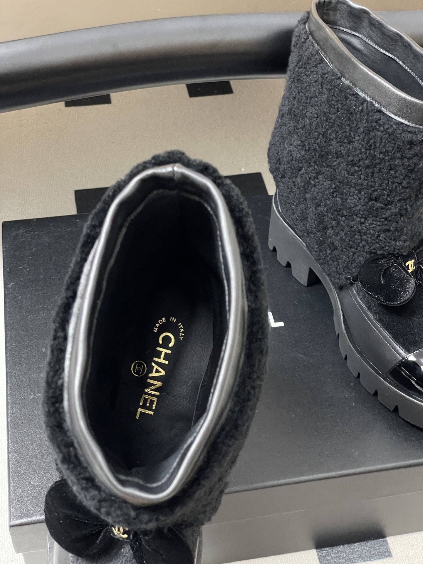 Pair of black luxury ankle boots with faux fur shearling shaft, velvet bow, and chunky lug soles - Hình 6