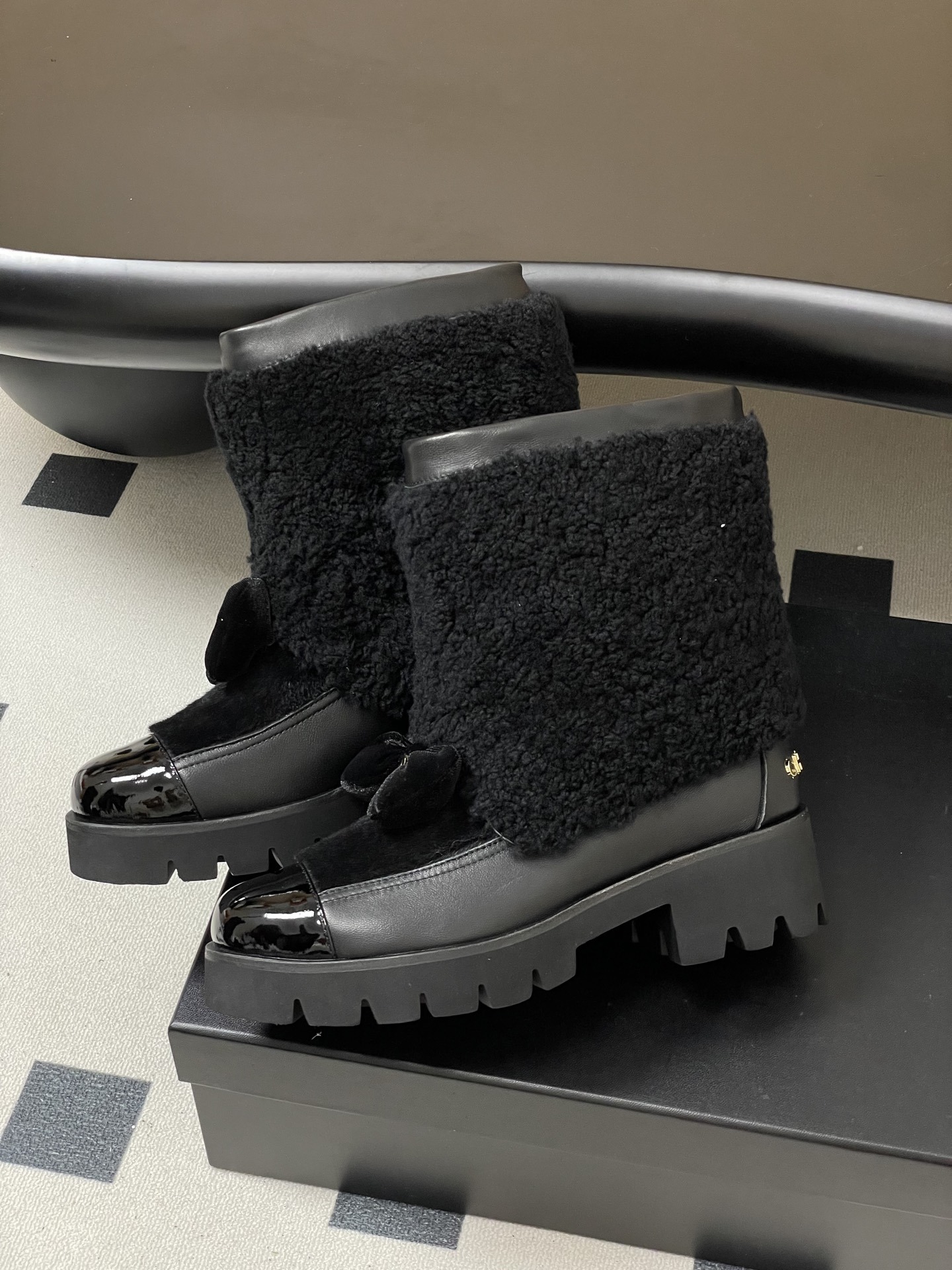 Pair of black luxury ankle boots with faux fur shearling shaft, velvet bow, and chunky lug soles - Hình 4