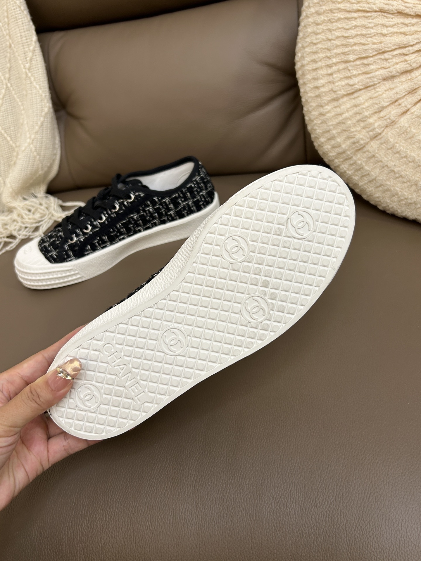 Top view of a pair of Chanel black and white tweed low-top sneakers with white rubber toe caps and CC logo. - Hình 9