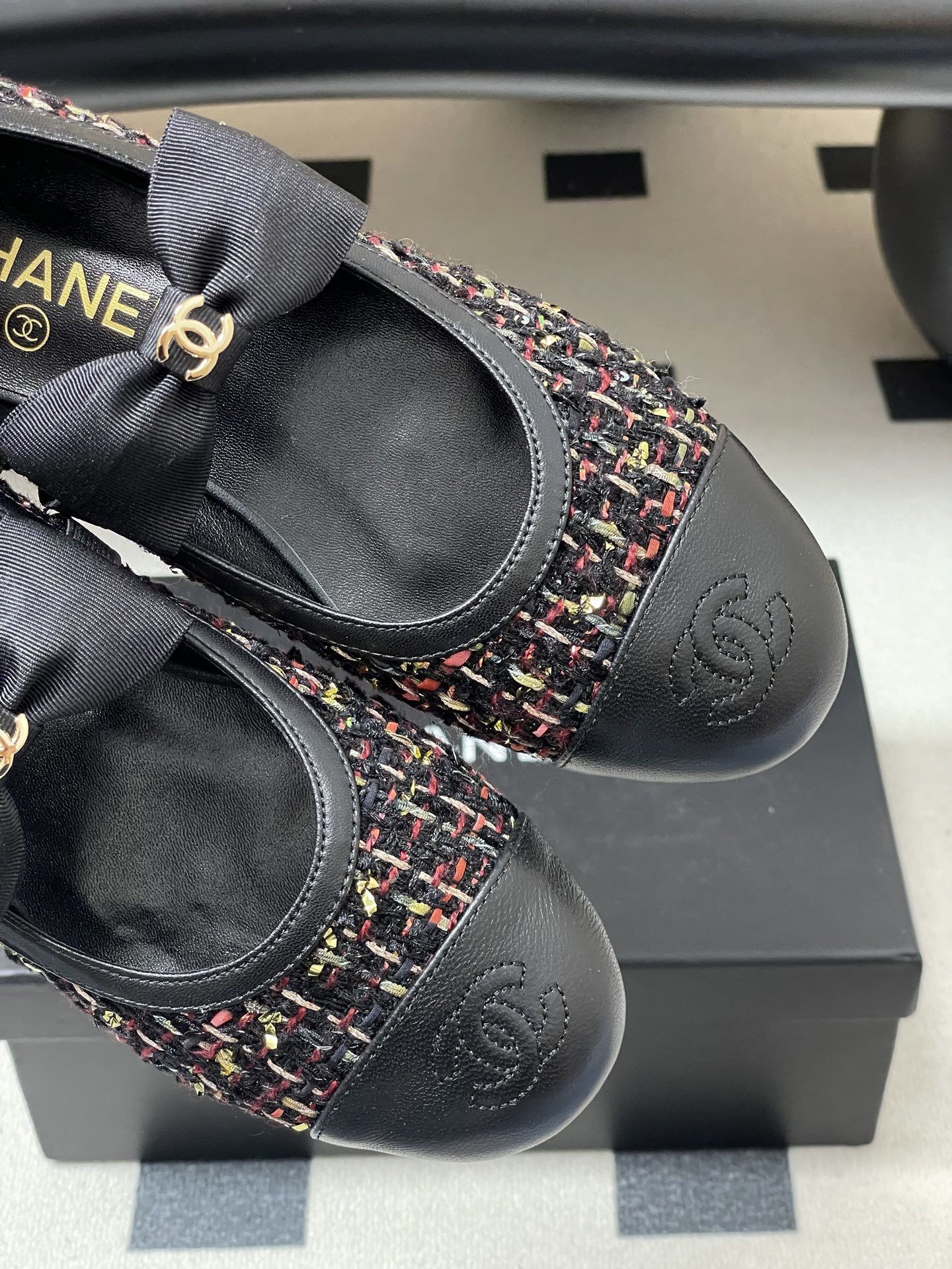 A pair of Chanel multi-color tweed ballet flats with black leather toe caps and grosgrain bows featuring gold CC logos. - Hình 9