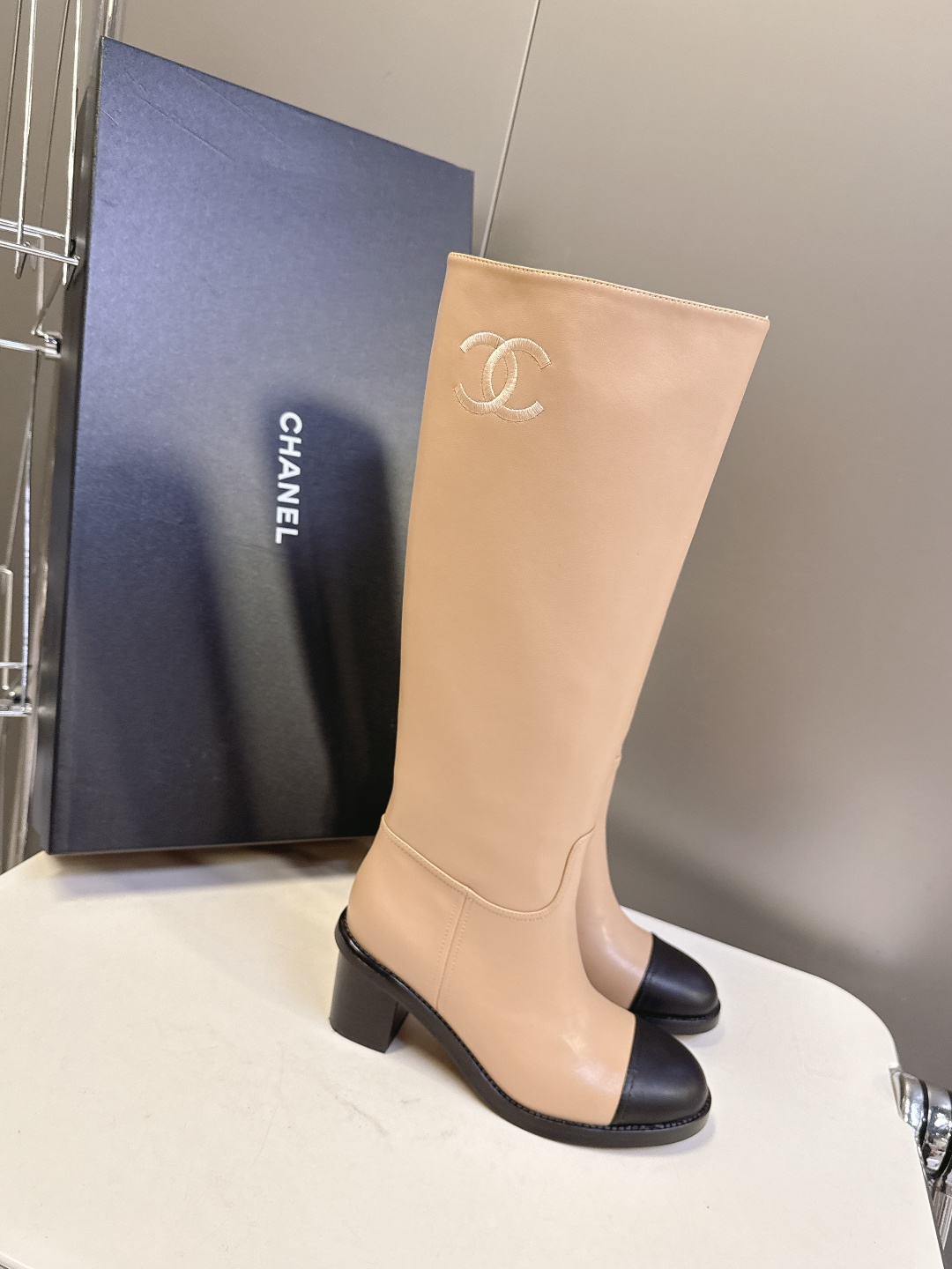 Chanel beige leather knee-high boots with black cap toe and embroidered CC logo on the side - Hình 2