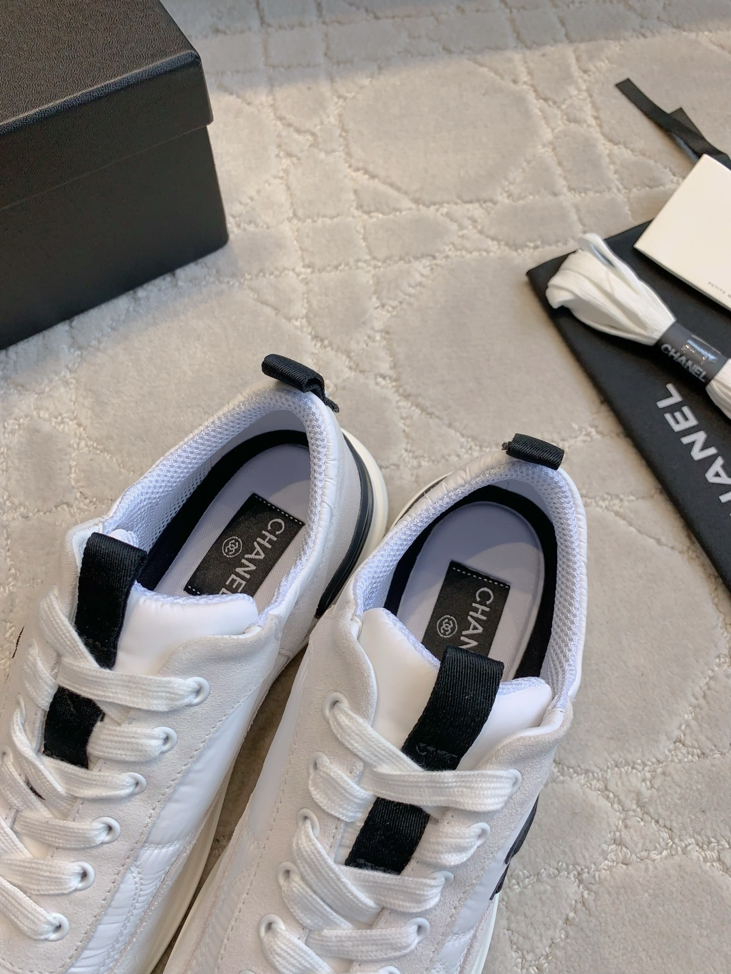 Authentic Chanel white and grey low-top sneakers with black CC logo, shown with original box, dust bag, and accessories. - Hình 6