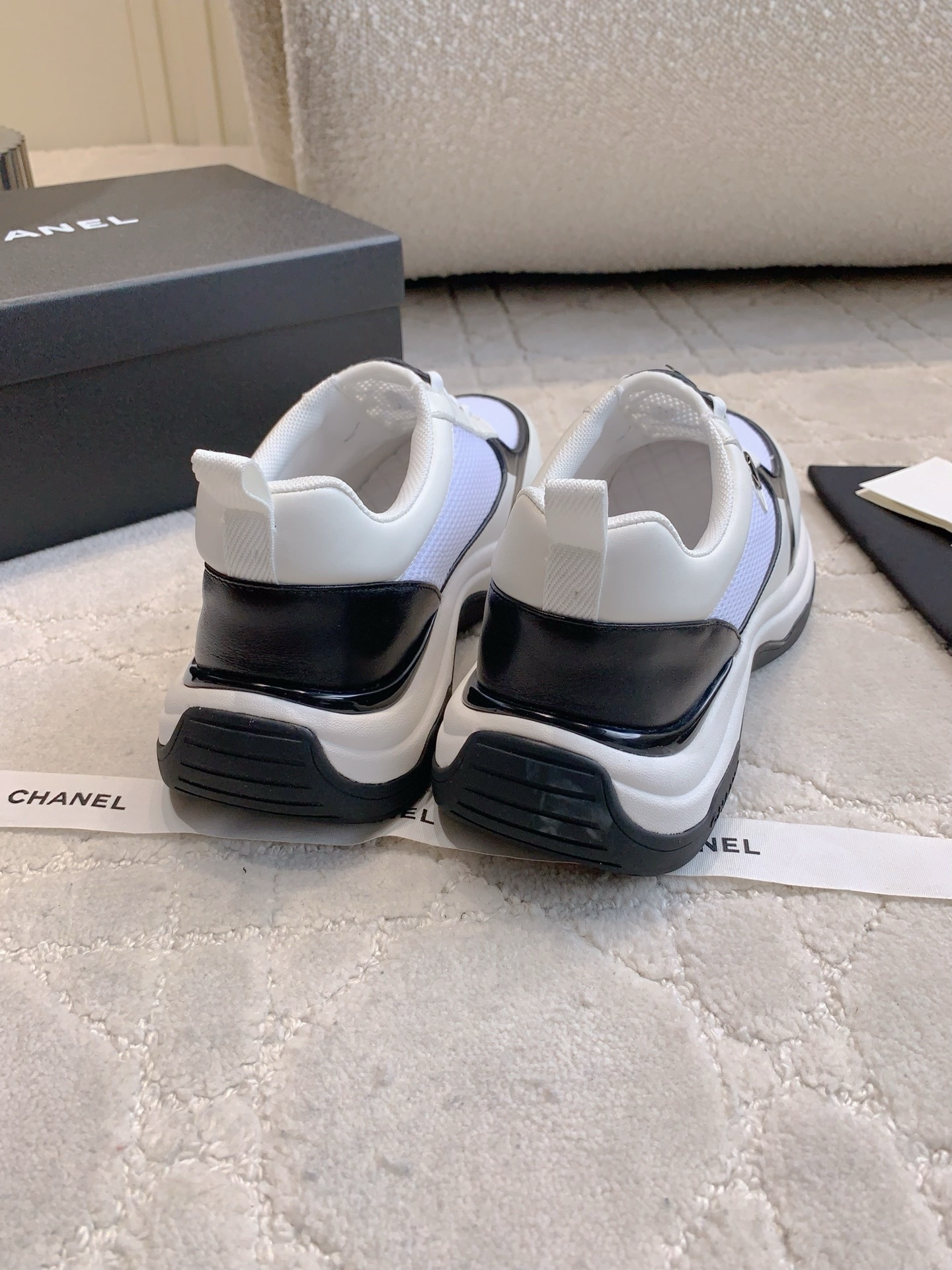 Chanel white and black mesh sneakers with CC logo and chunky sole displayed with original luxury packaging. - Hình 8