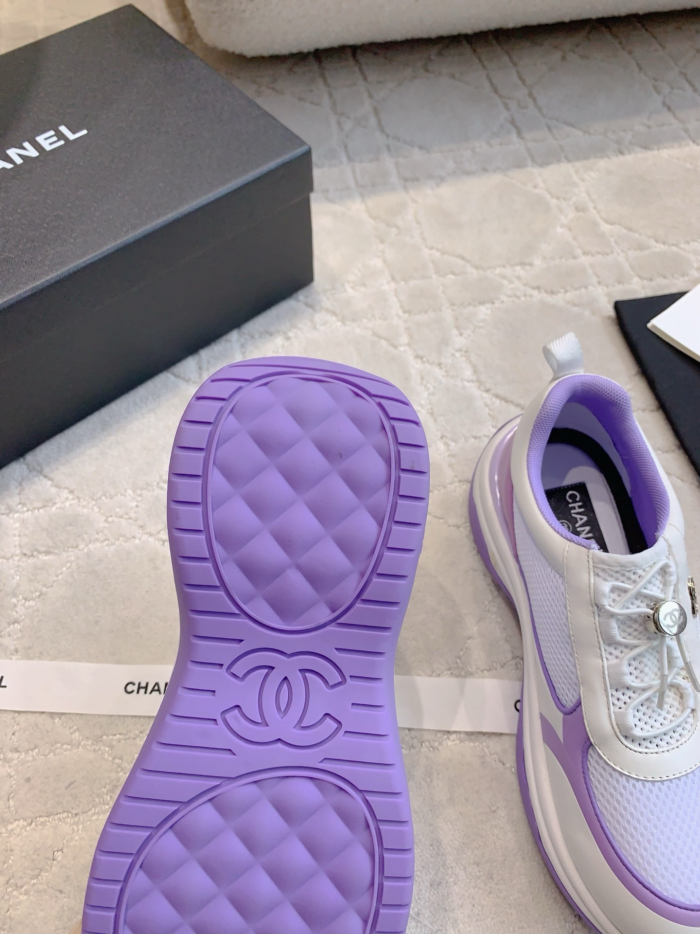 A pair of Chanel purple and white mesh chunky sneakers with CC logo hardware and brand packaging - Hình 9