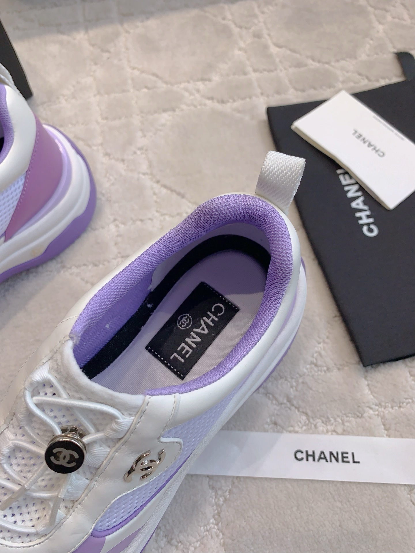 A pair of Chanel purple and white mesh chunky sneakers with CC logo hardware and brand packaging - Hình 7