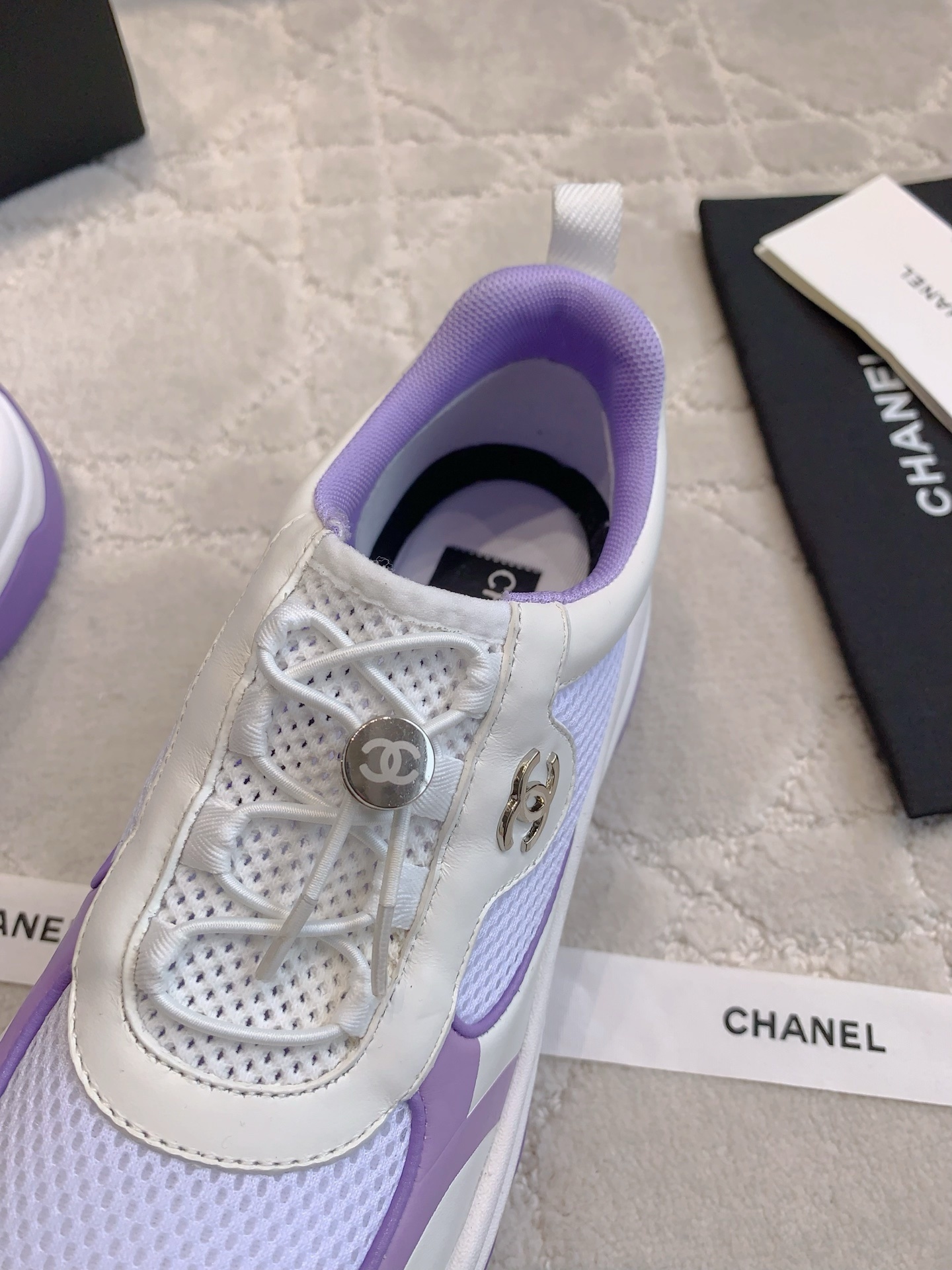 A pair of Chanel purple and white mesh chunky sneakers with CC logo hardware and brand packaging - Hình 6