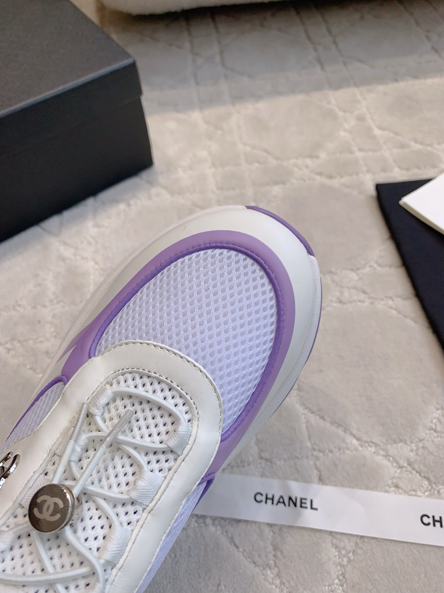 A pair of Chanel purple and white mesh chunky sneakers with CC logo hardware and brand packaging - Hình 5