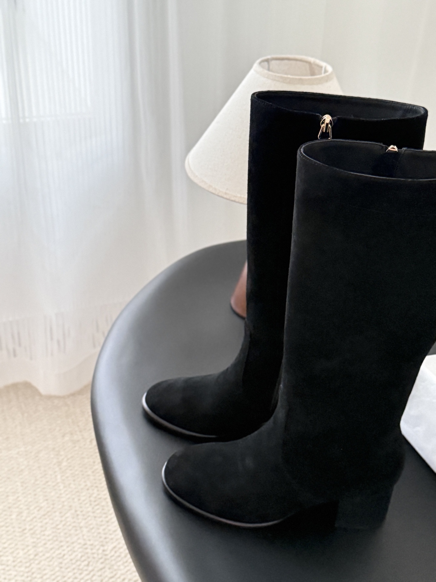 Pair of elegant black suede knee-high boots featuring a gold logo and a comfortable block heel. - Hình 7
