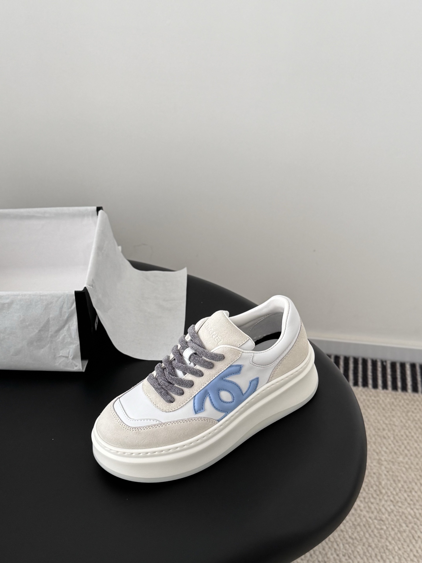 Pair of Chanel white and light blue platform sneakers with a black designer box - Hình 6