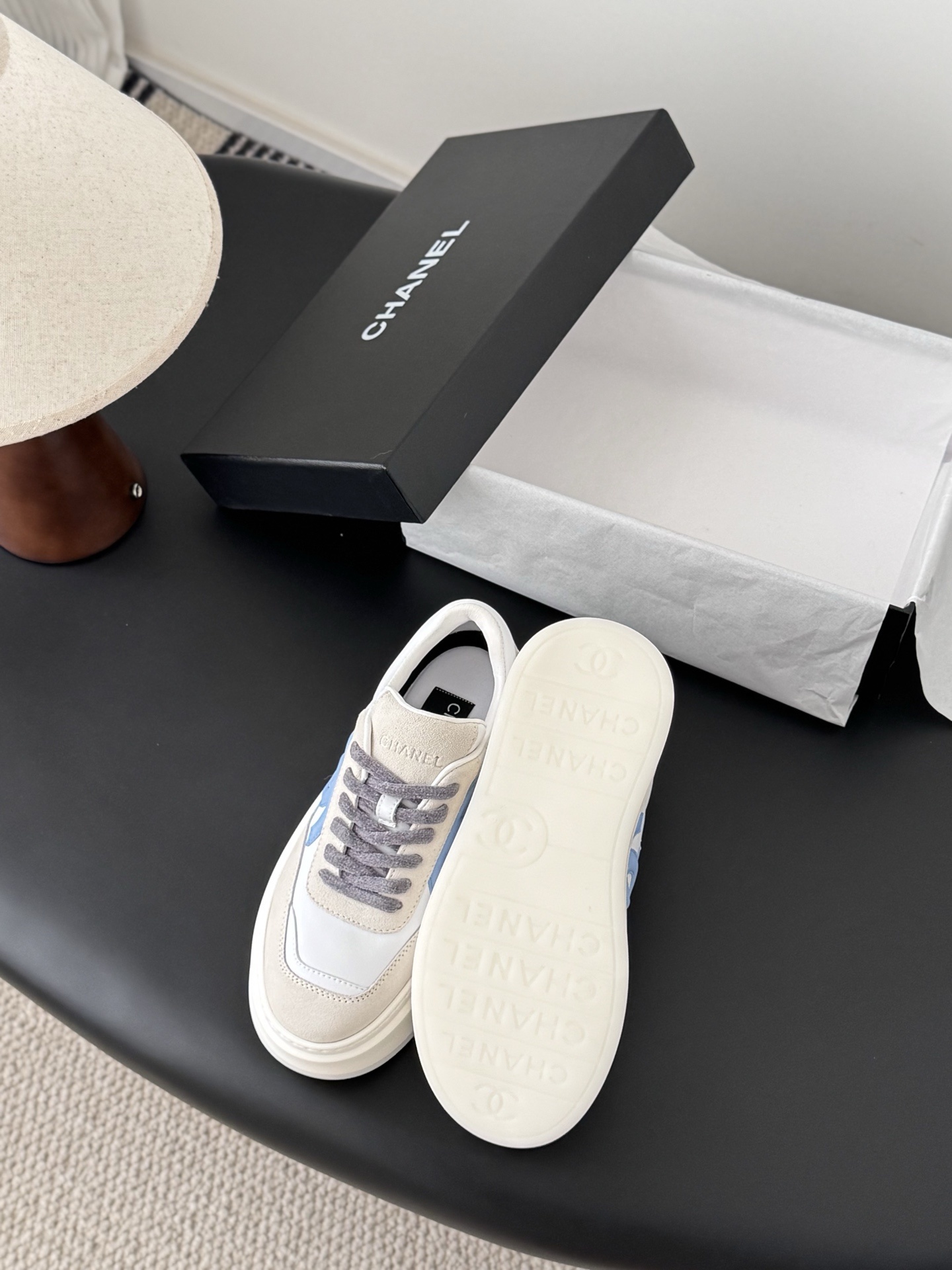 Pair of Chanel white and light blue platform sneakers with a black designer box - Hình 4