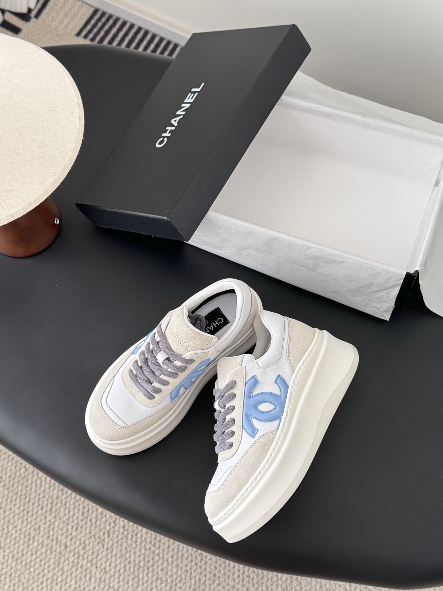 Pair of Chanel white and light blue platform sneakers with a black designer box - Hình 3