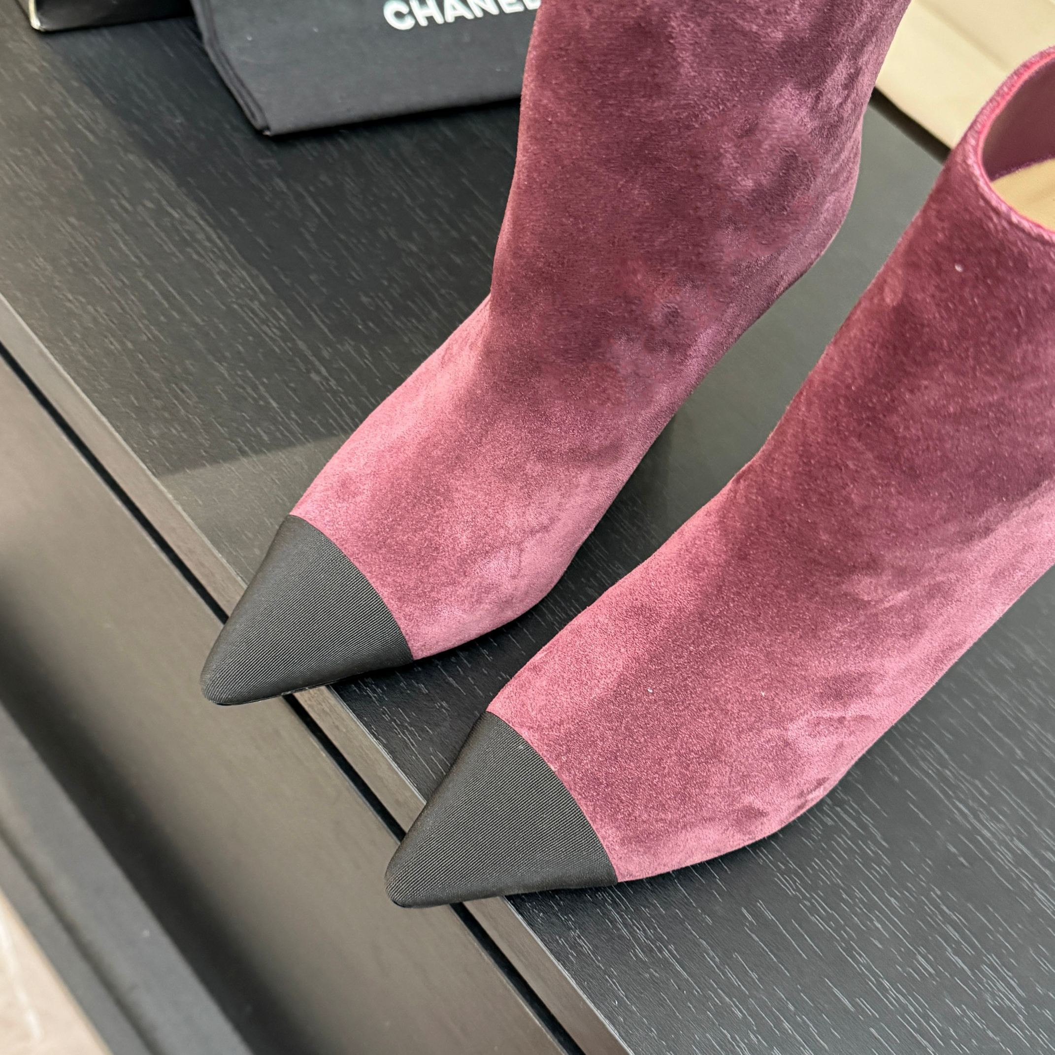 Burgundy Chanel suede ankle boots with black pointed cap toes and Gabrielle Chanel COCO embroidery on the side. - Hình 3