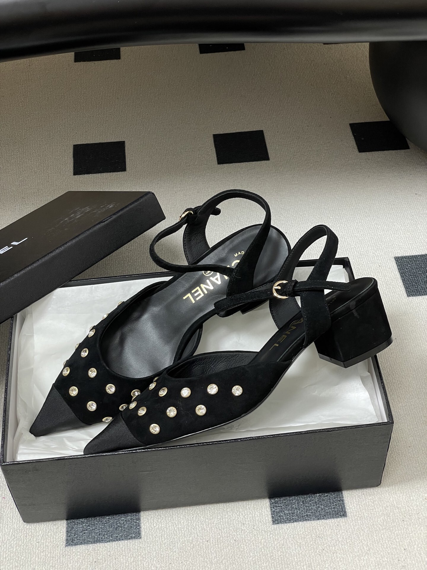 Chanel black suede slingback pumps with crystal embellishments and low block heels displayed on a black surface - Hình 4